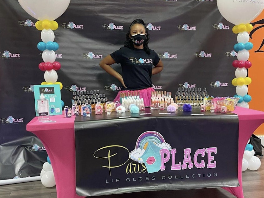 caption: Paris Muhammad, CEO of Paris Place LLC, at the ribbon-cutting ceremony celebrating the moment she made history as the youngest member of the Conyers-Rockdale Chamber of Commerce in Georgia.