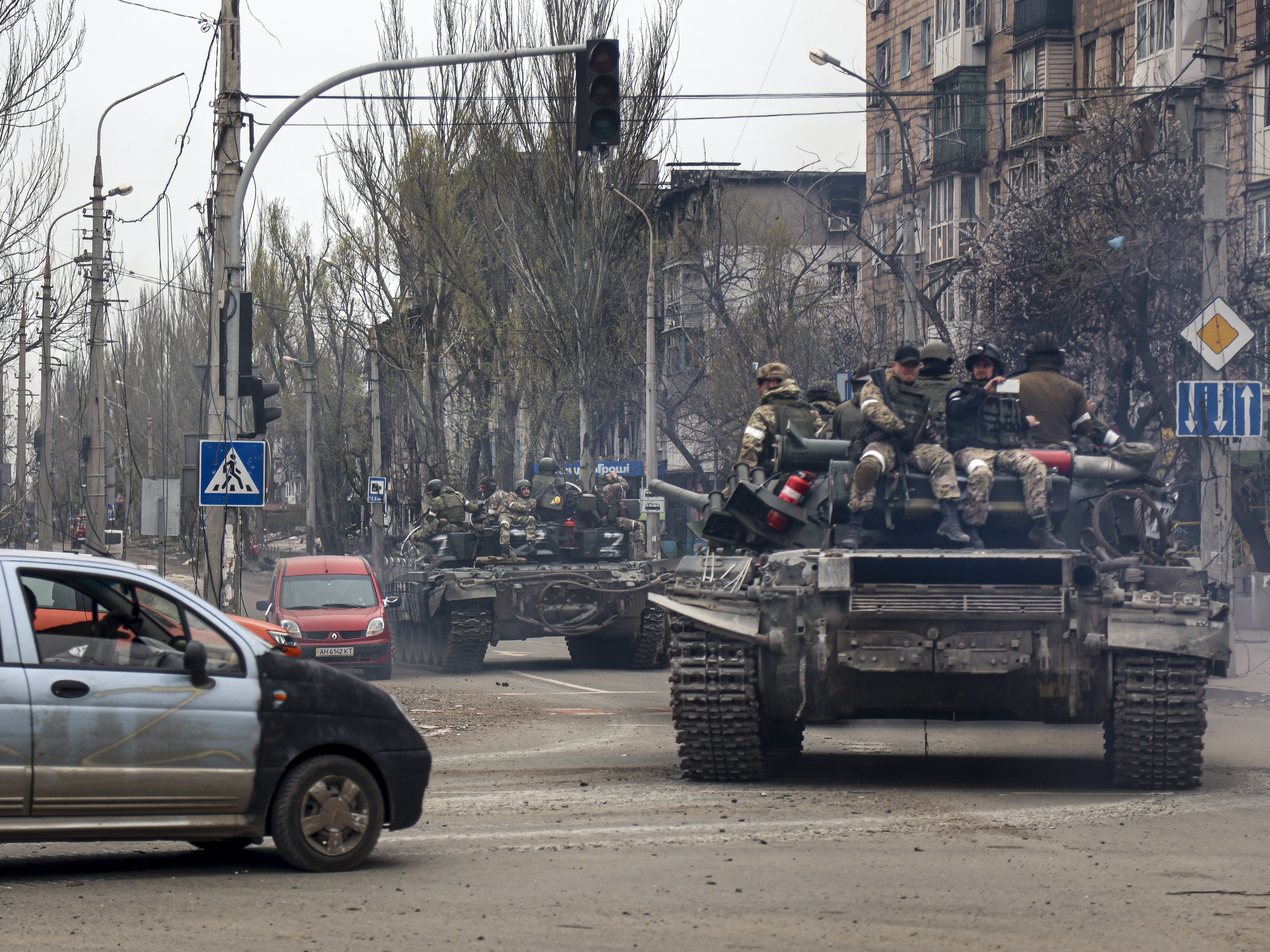 caption: Russian tanks roll along a street in an area controlled by Russian-backed separatist forces in Mariupol, Ukraine, on April 23, 2022.