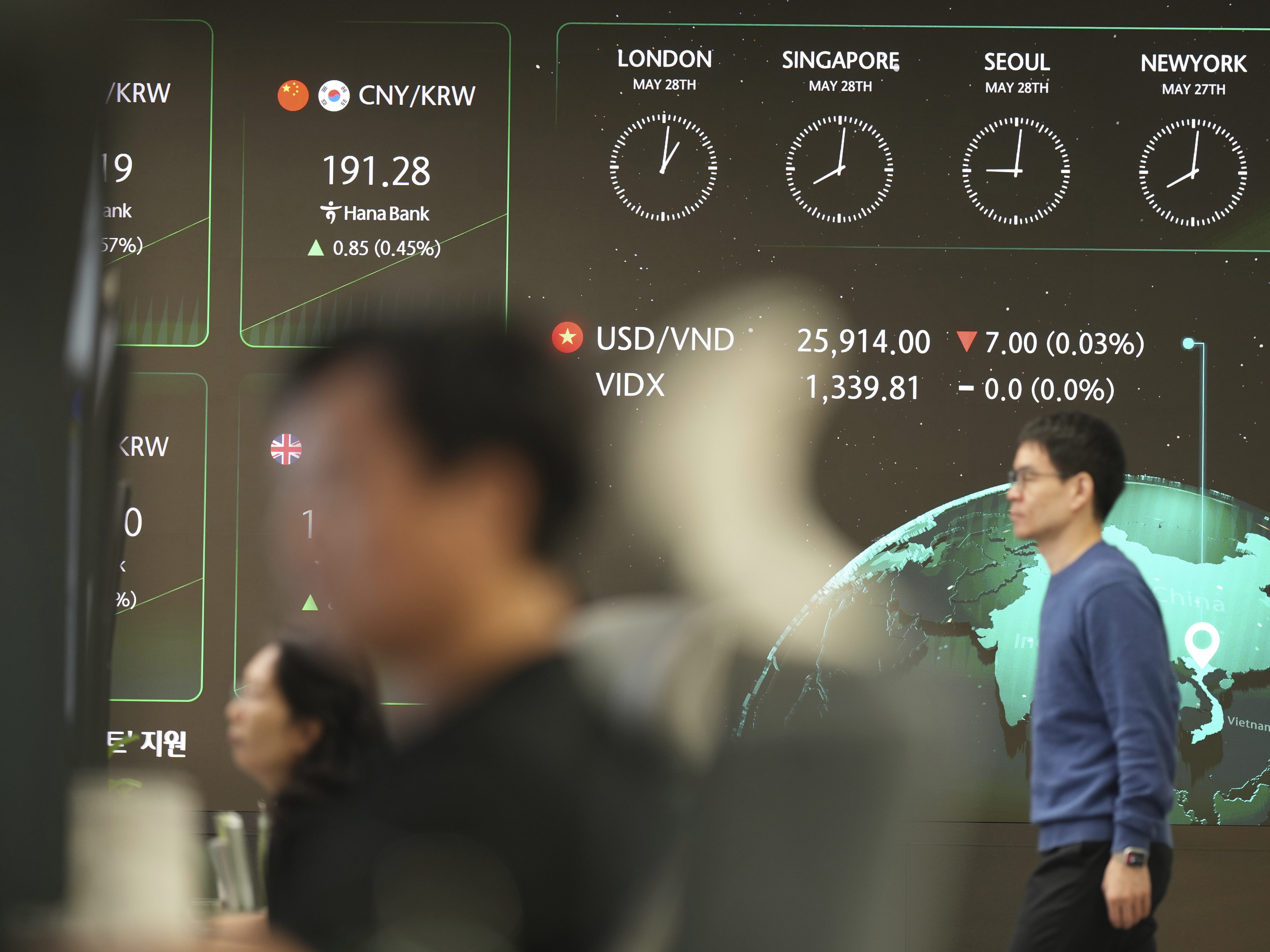 caption: The screens show the foreign exchange rates at a dealing room of Hana Bank in Seoul, South Korea, on Wednesday.