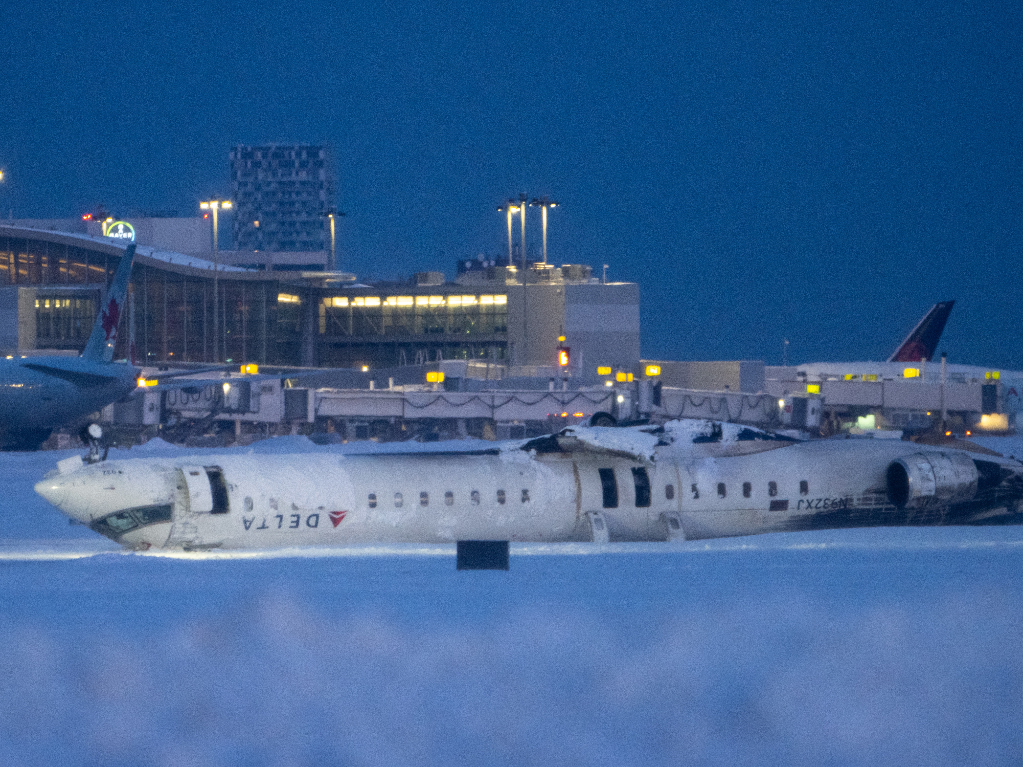 caption: Canadian investigators say a Delta Air Lines regional jet that crashed while attempting to land at the Toronto Pearson International Airport last month was descending too quickly. The plane flipped over after the hard landing. None of the 80 people on board died but two passengers were seriously injured.