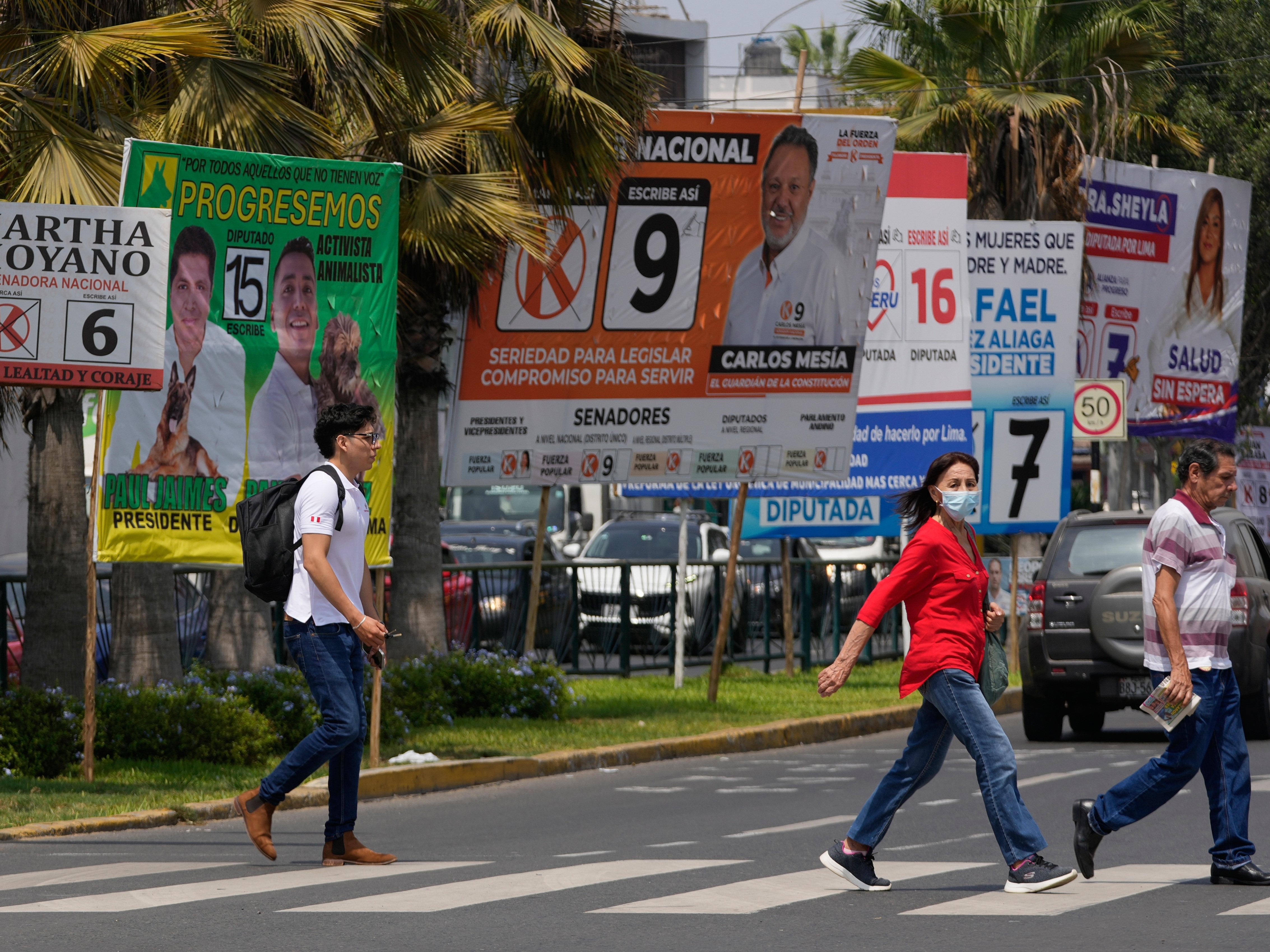 caption: Pedestrians pass election campaign signs for presidential and congressional candidates, before the weekend's election in Lima, Peru, April 10, 2026.