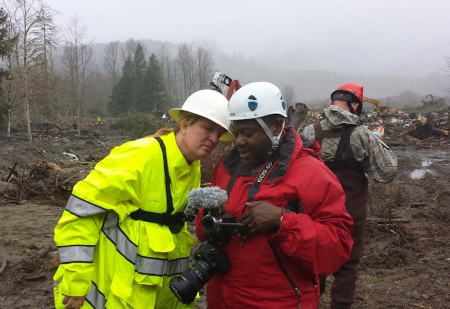 Volunteer Merry Killinger learns from Stacy Noland how to document rescue and recovery efforts in Oso, Wash.