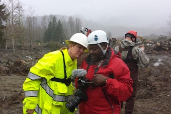 caption: Volunteer Merry Killinger learns from Stacy Noland how to document rescue and recovery efforts in Oso, Wash.
