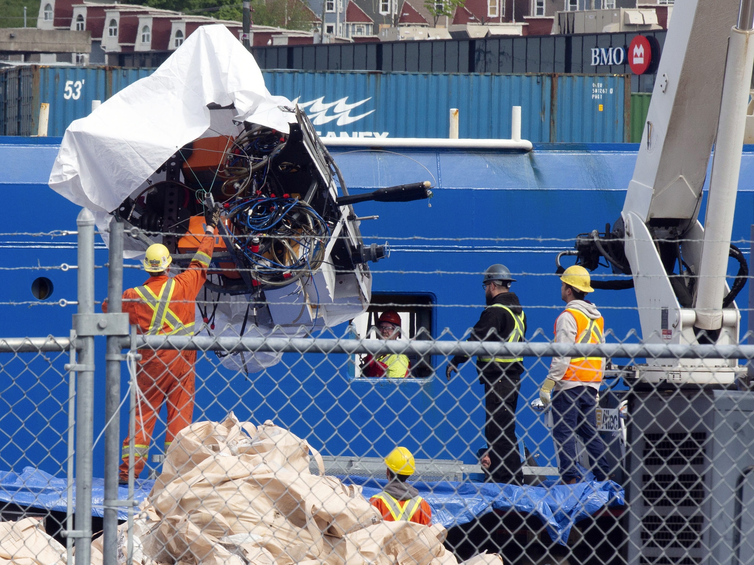 caption: Debris from the Titan submersible, recovered from the ocean floor, is unloaded from the ship Horizon Arctic at the Canadian Coast Guard pier in St. John's, Newfoundland, on June 28, 2023.