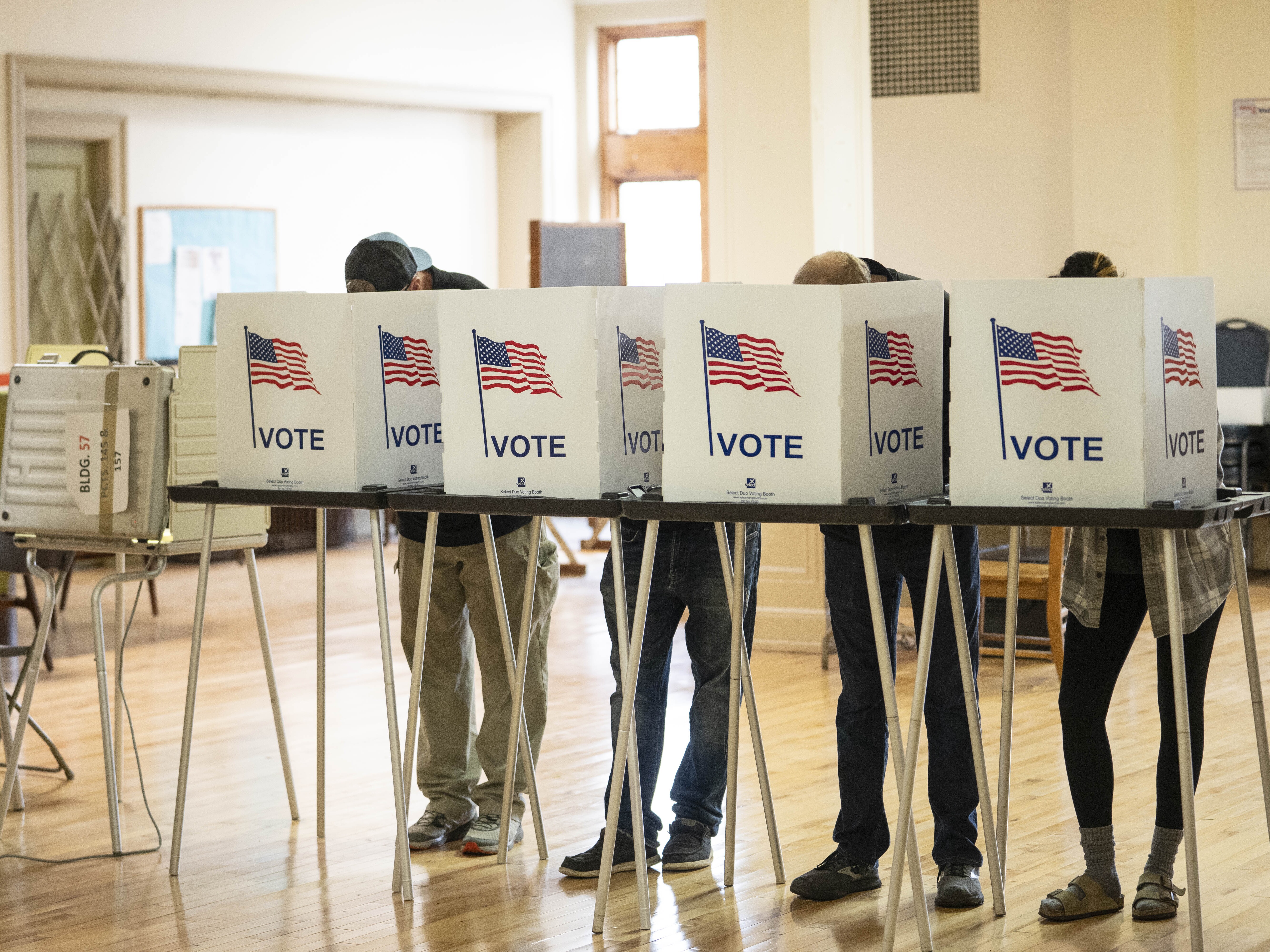 caption: Voters cast 2024 general election ballots in Detroit. A review by the Michigan secretary of state found 16 credible cases of noncitizen voting in Michigan in that election — out of 5.7 million votes cast.