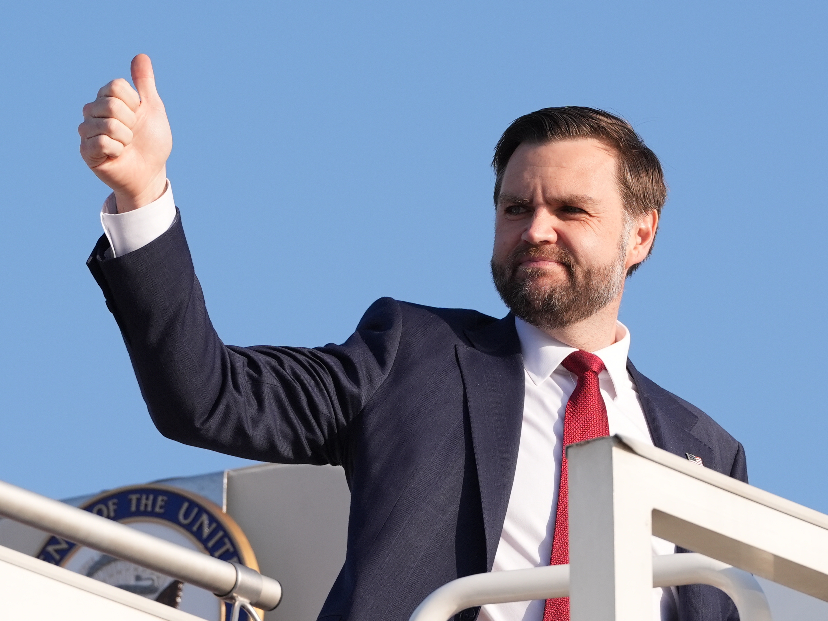caption: Vice President JD Vance gives a thumb up sign as he boards Air Force Two after attending talks on Iran in Islamabad, Pakistan, Sunday, April 12, 2026.