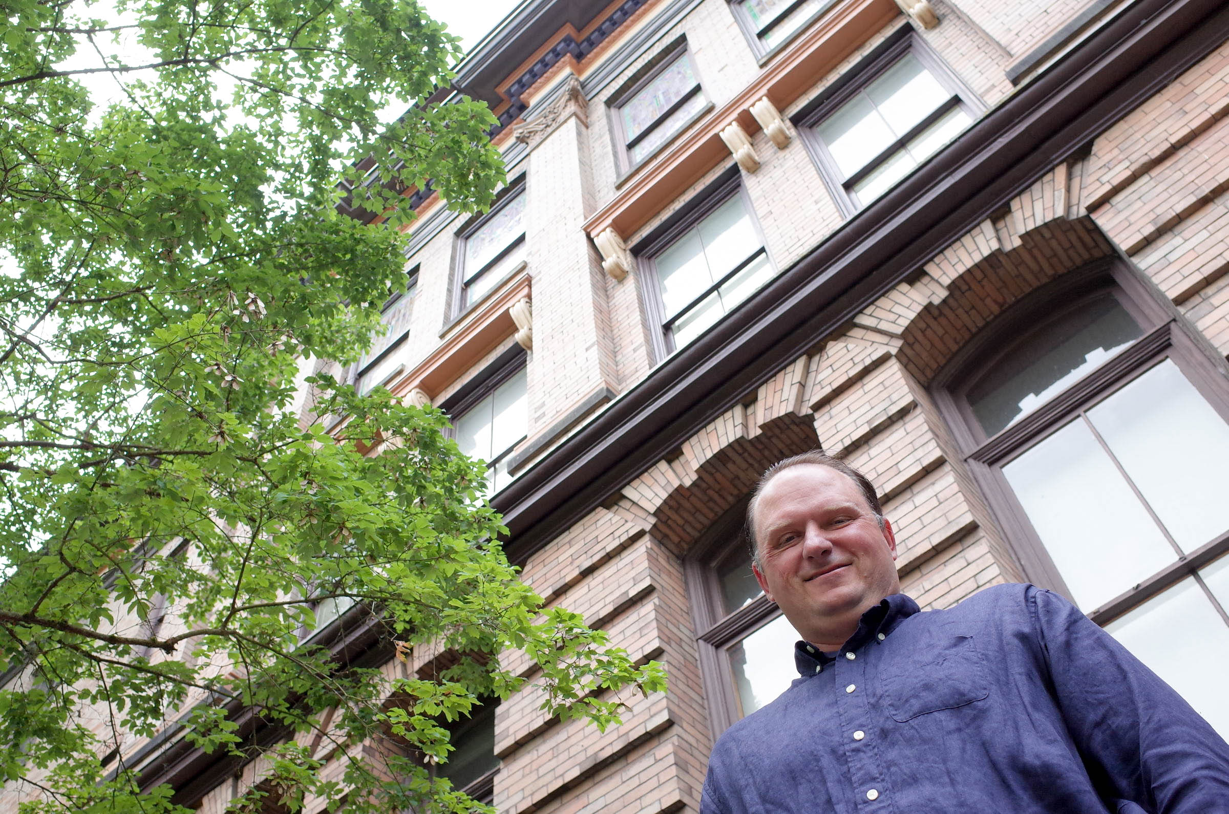 caption: Kji Kelly of Historic Seattle, at the Good Shepherd Center in Wallingford. The city of Seattle says the building is unreinforced masonry and is expected to be dangerous in a quake. These brick walls could collapse, hurting people inside and outside.