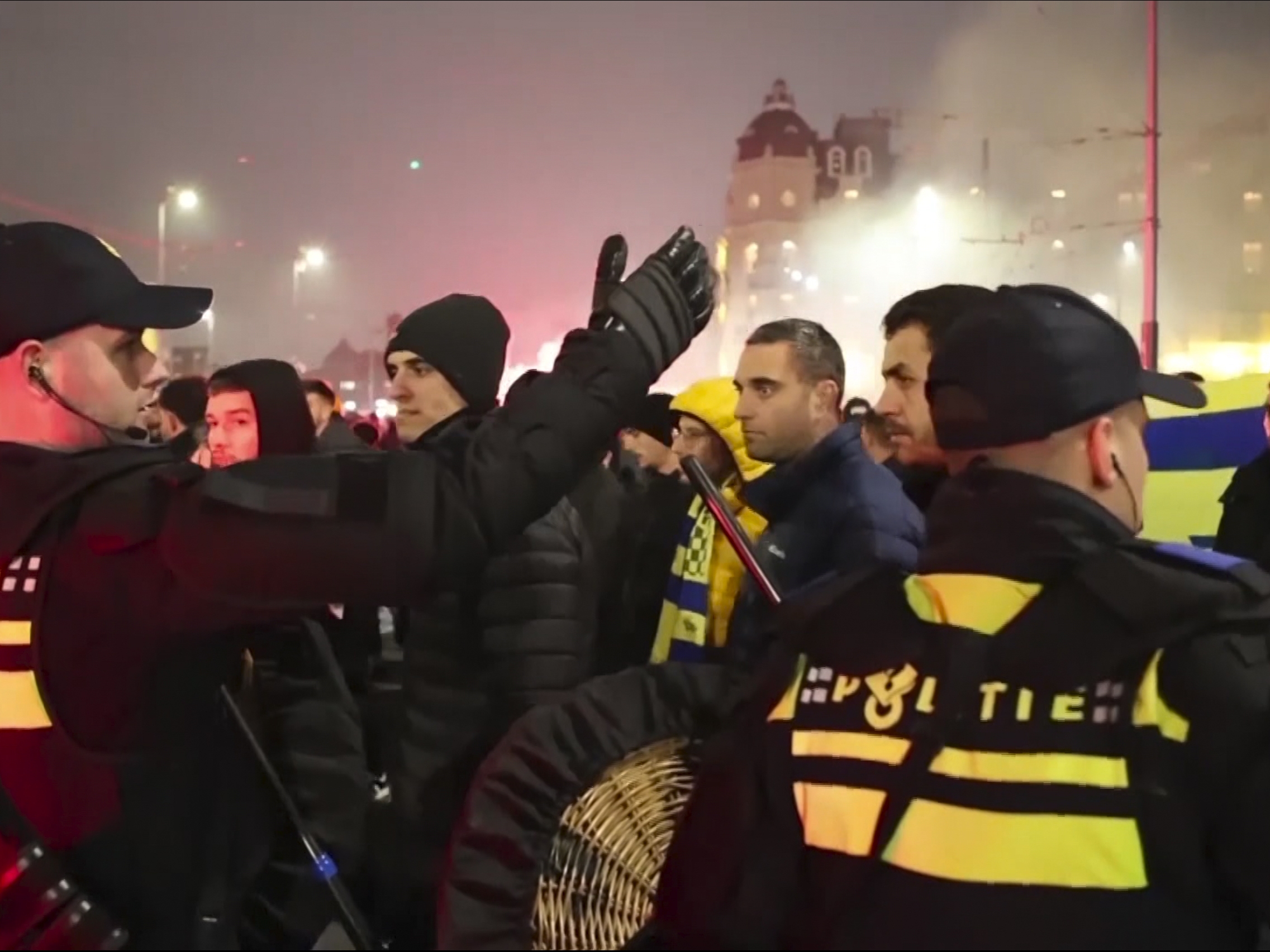 caption: In an image taken from video, police are seen escorting Maccabi Tel Aviv soccer team supporters to the metro station, leading them to the Ajax stadium, after pro-Palestinian supporters marched near the stadium, in Amsterdam, Thursday.