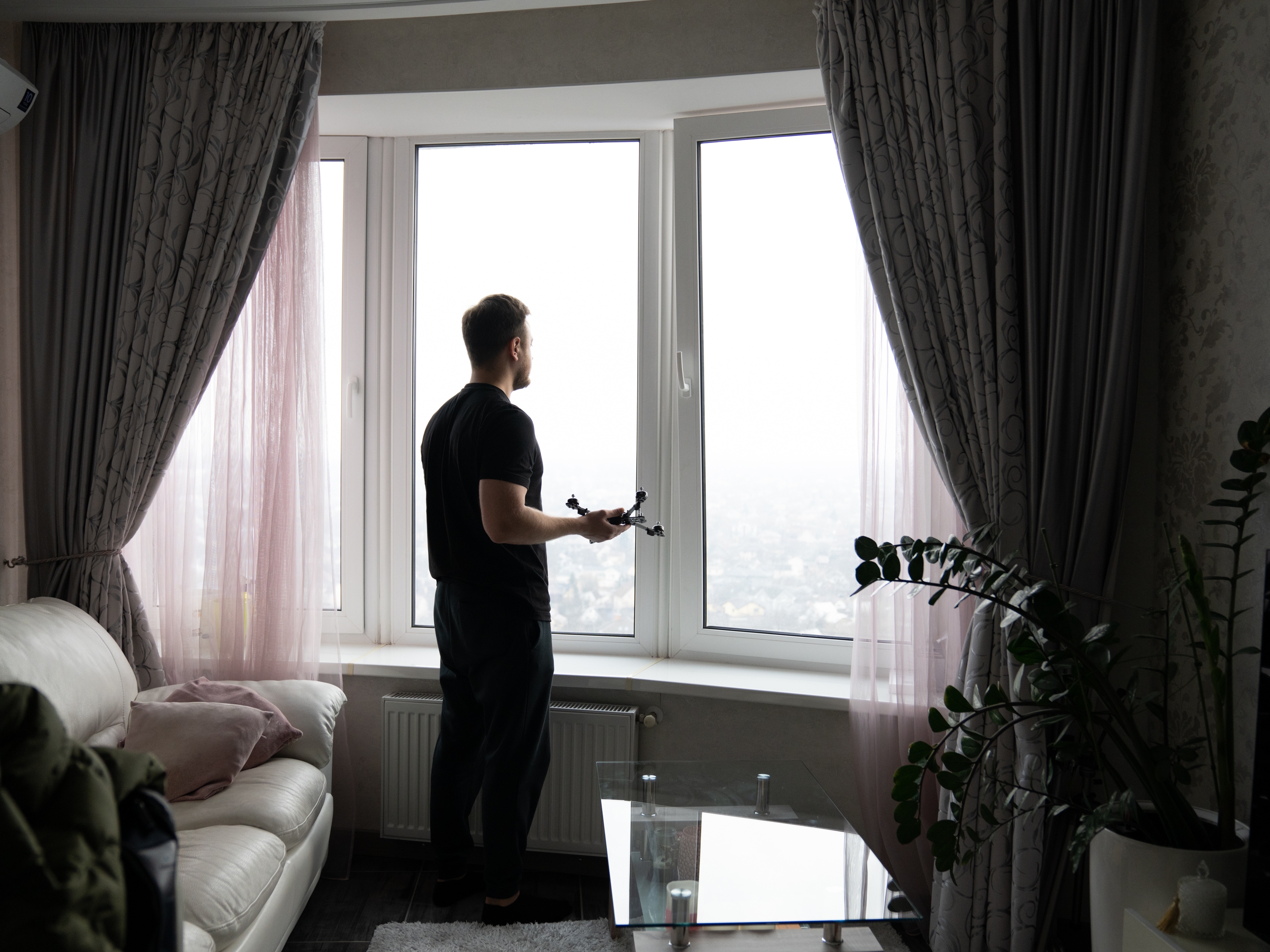 caption: Anton, who doesn't want his name used for security concerns, builds drones with the company Social Drone in his kitchen in Kyiv, Ukraine.