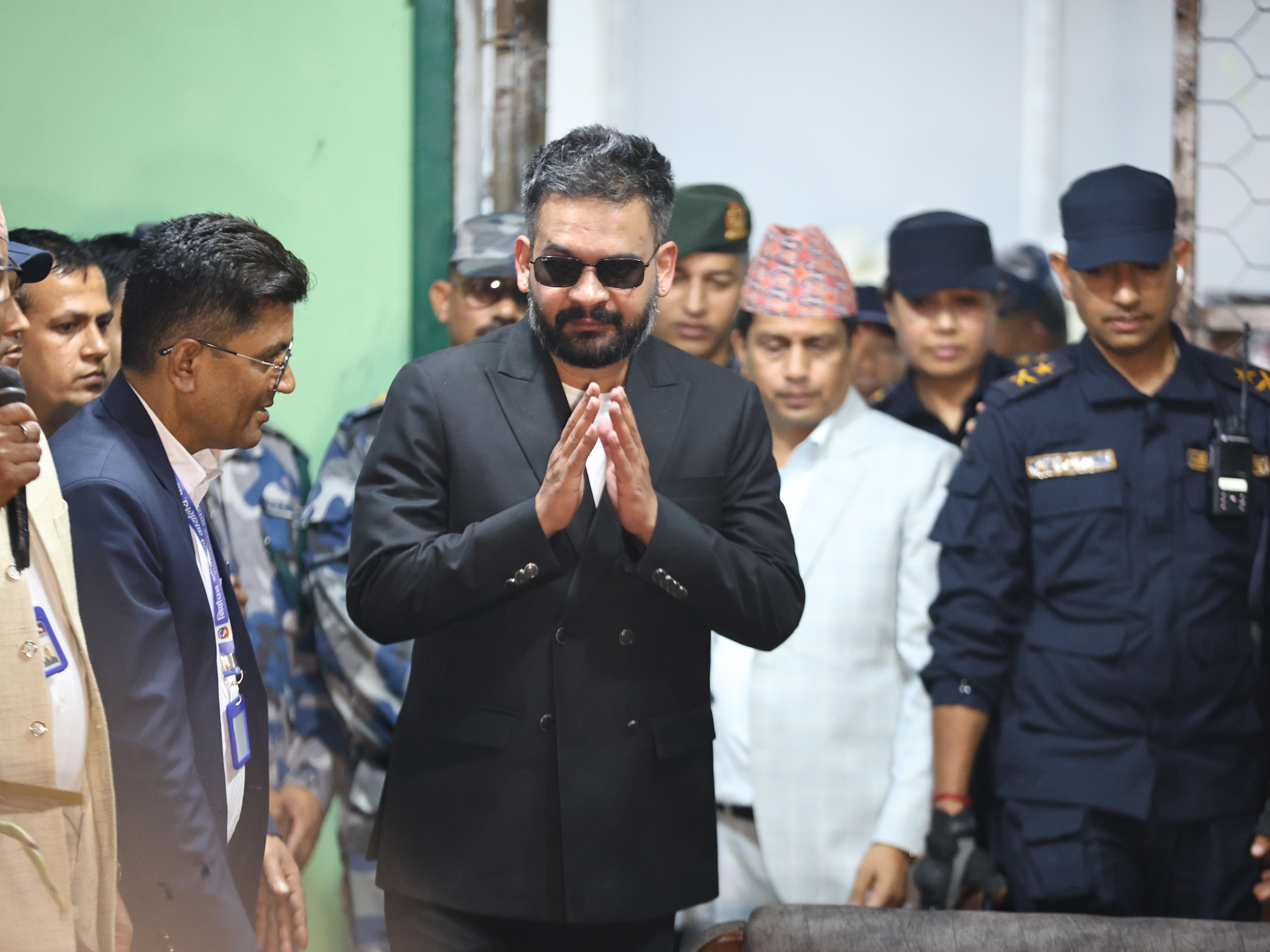 caption: Balendra Shah, foreground, former mayor of Kathmandu Metropolitan City and prime ministerial candidate of the Rastriya Swatantra Party, arrives to receive his victory certificate after defeating former Prime Minister Khadga Prasad Oli of the Communist Party of Nepal–Unified Marxist-Leninist (CPN-UML) in Jhapa, about 267 miles (430 kilometers) southeast of Kathmandu, Nepal, Sunday, March 8, 2026.