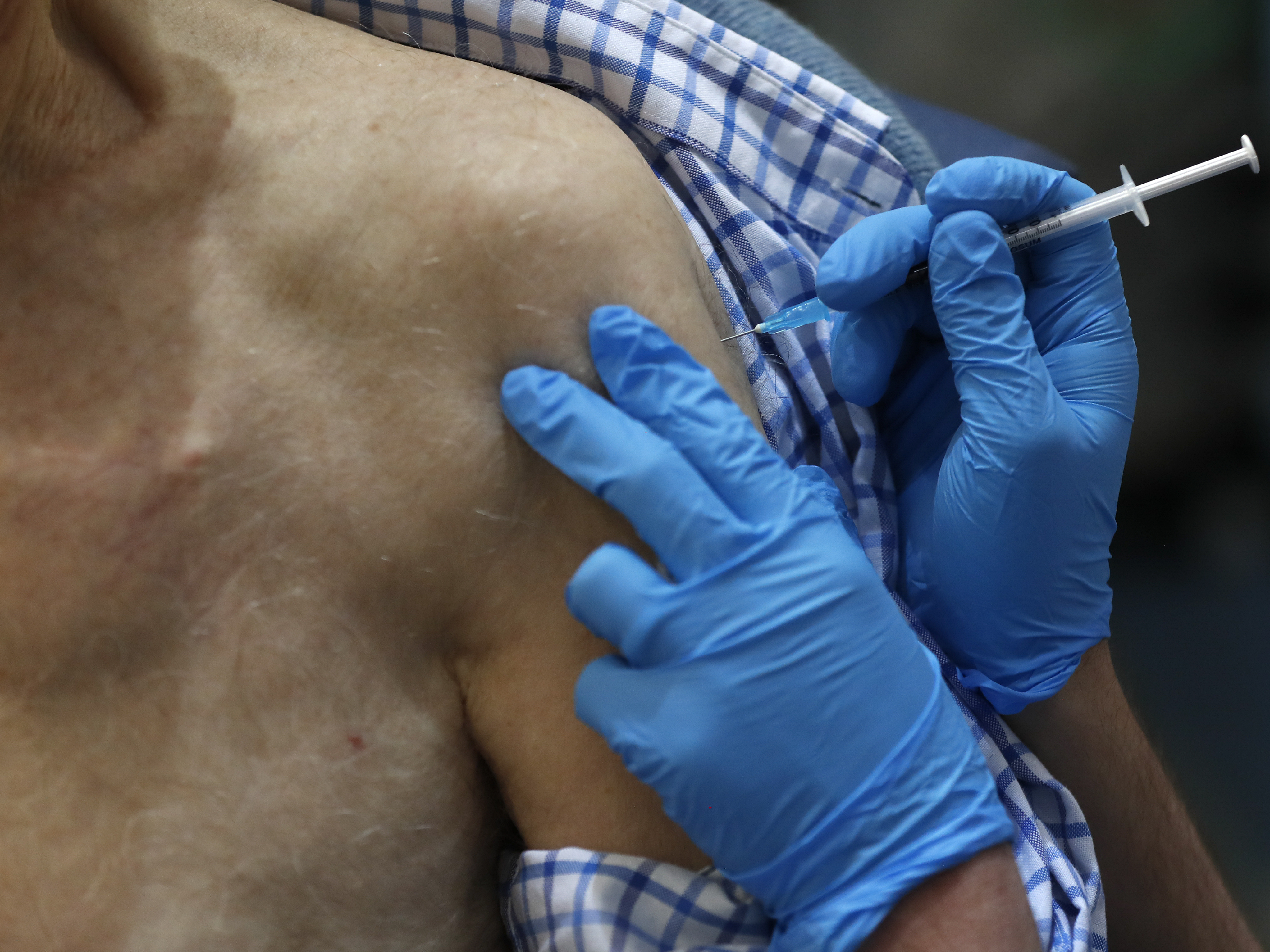 caption: The U.K. launched its largest-ever immunization program Tuesday. Health officials began dispensing doses of the Pfizer and BioNTech coronavirus vaccine, first vaccinating health care workers and residents over the age of 80.