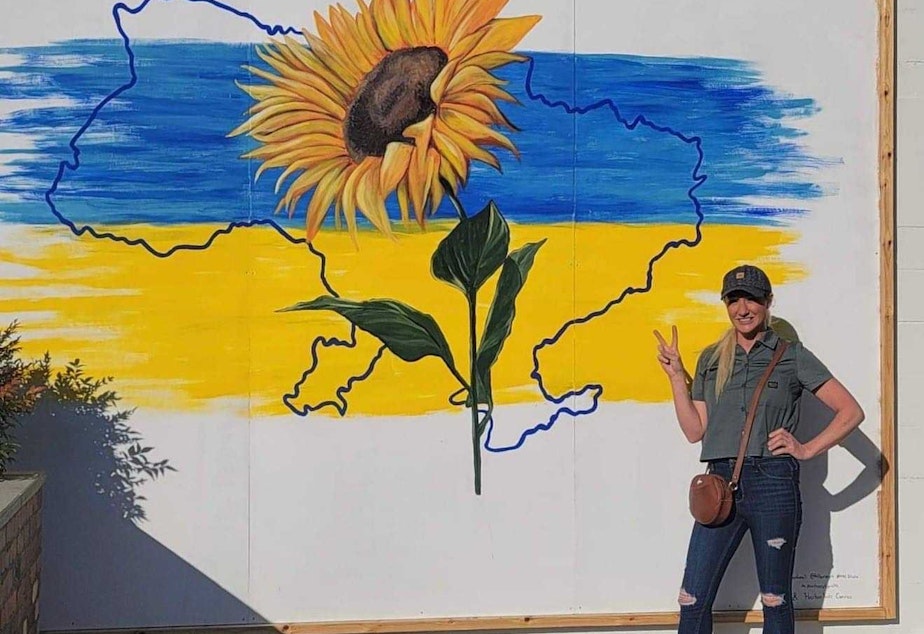 caption: Artist Hillarie Isackson's original mural to support Ukraine