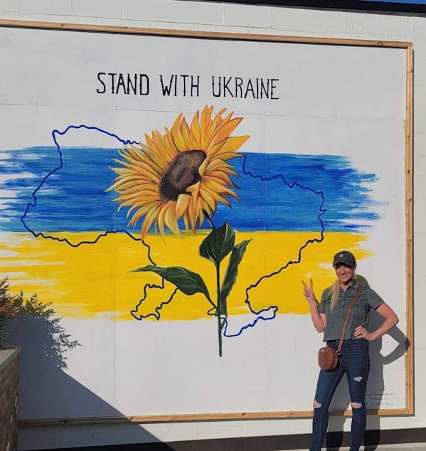 caption: Artist Hillarie Isackson's original mural to support Ukraine