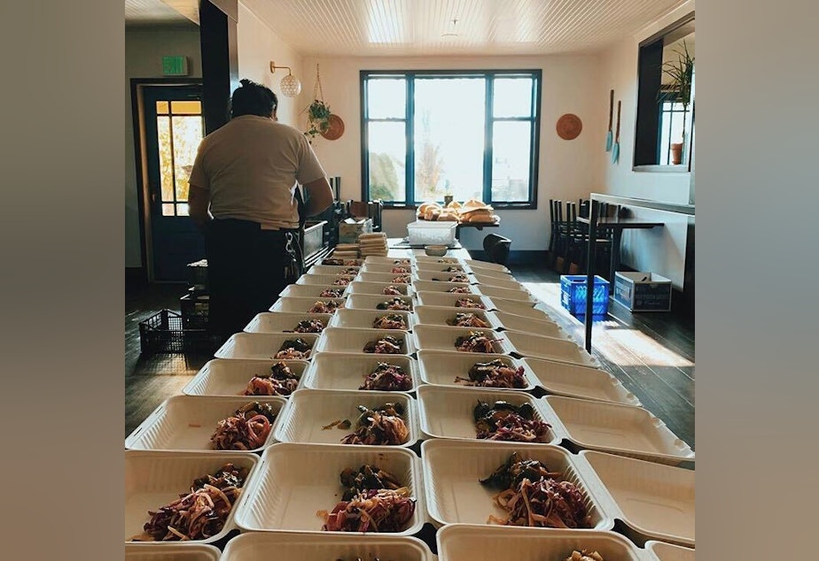 caption: Orders being prepared to go at Beacon Hill's Musang restaurant.