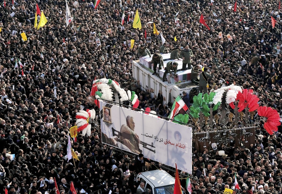 caption: During a funeral procession at Revolution Square in Tehran on Monday, crowds surround the coffins of Iranian Maj. Gen. Qassem Soleimani and others killed in Iraq by a U.S. drone strike.