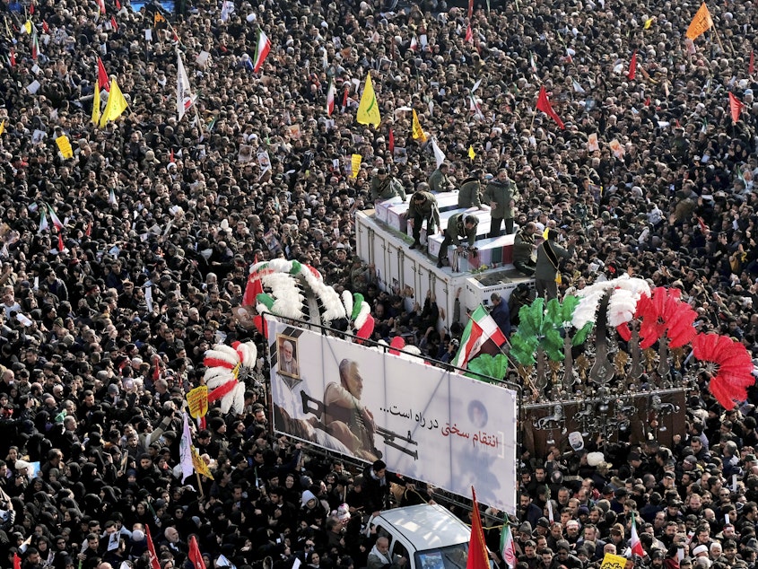 caption: During a funeral procession at Revolution Square in Tehran on Monday, crowds surround the coffins of Iranian Maj. Gen. Qassem Soleimani and others killed in Iraq by a U.S. drone strike.