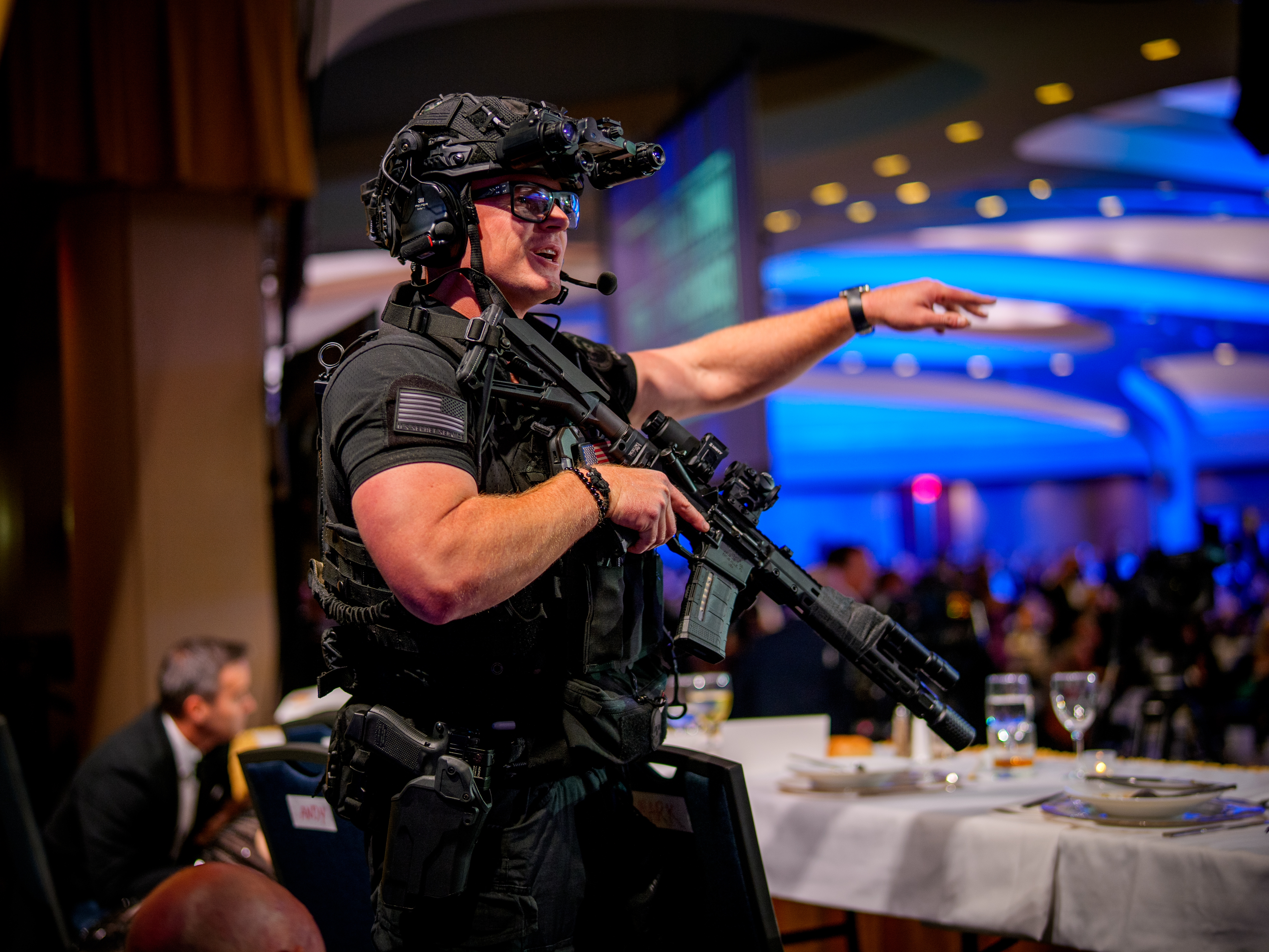 caption: Armed Secret Service agents stand on stage during a shooting incident at the annual White House Correspondents' Association Dinner at the Washington Hilton on Saturday in Washington, D.C. According to reports, President Donald Trump, along with other government officials, were rushed from the Washington Hilton after reports of gun shots.
