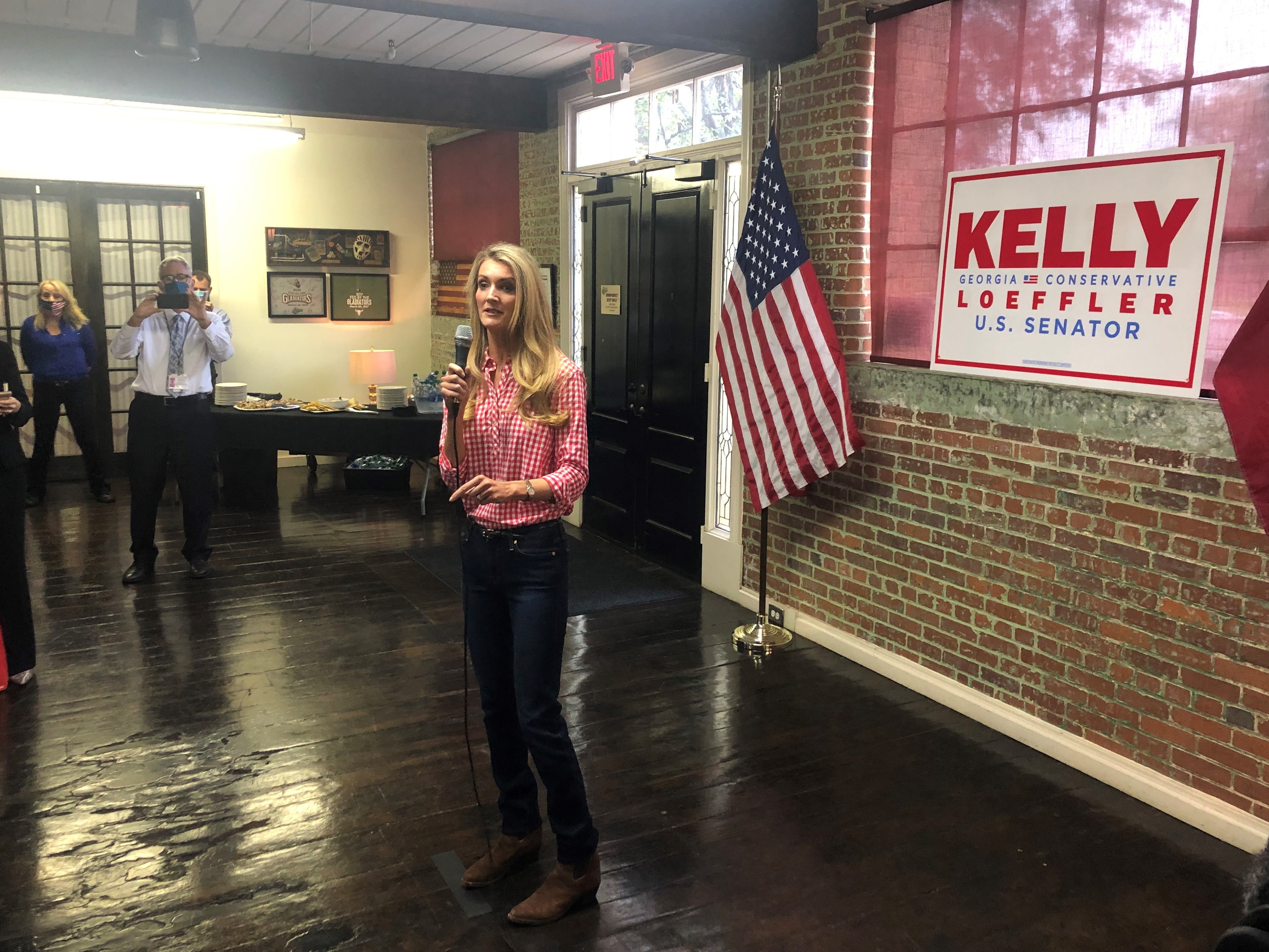 caption: Republican Sen. Kelly Loeffler campaigns in Buford, Ga., telling supporters she's 100% with President Trump.