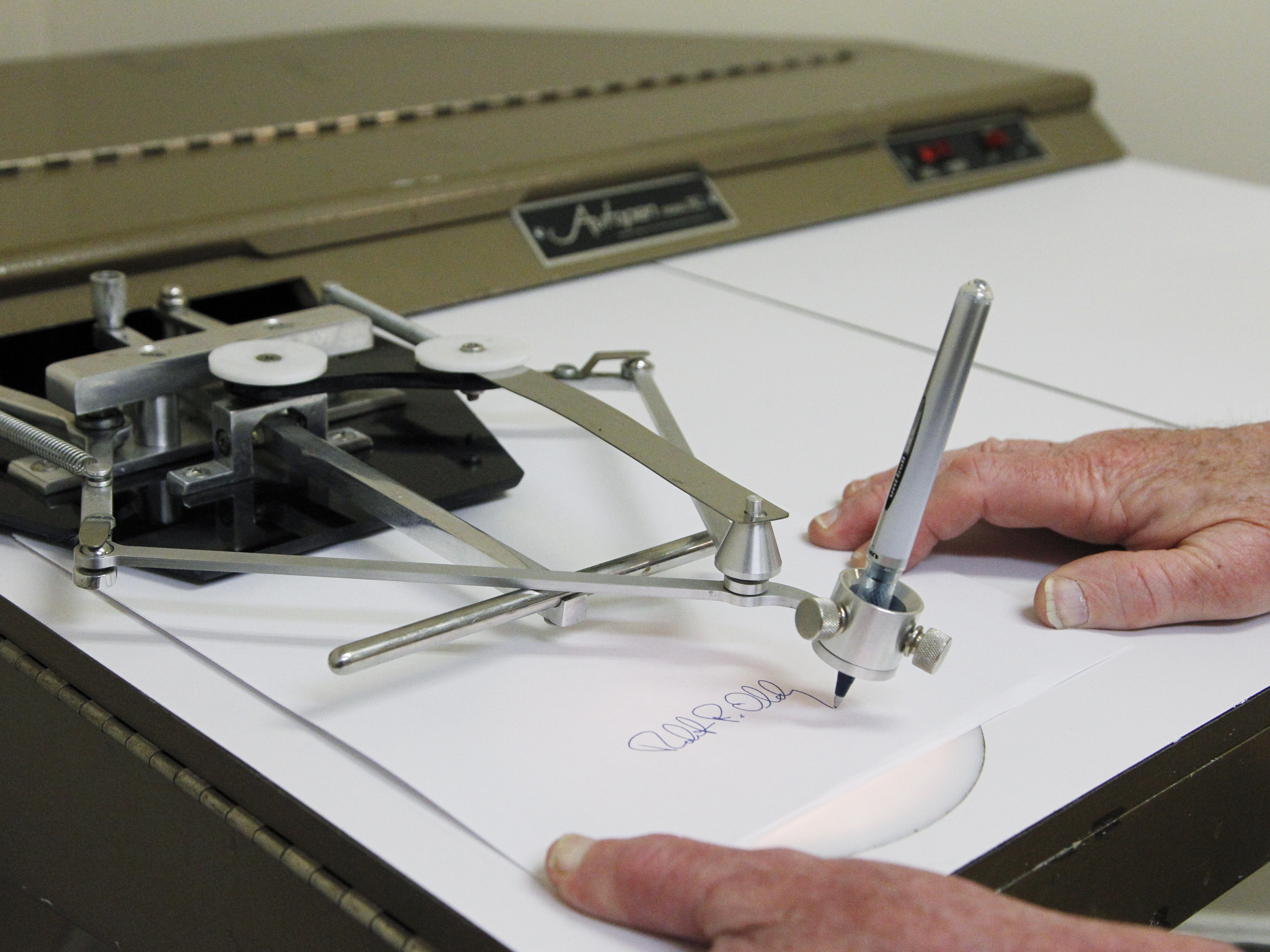 caption: The Autopen Model 80 in 2011. President Trump is accusing Biden of using an autopen to sign documents, as many presidents have over the years.