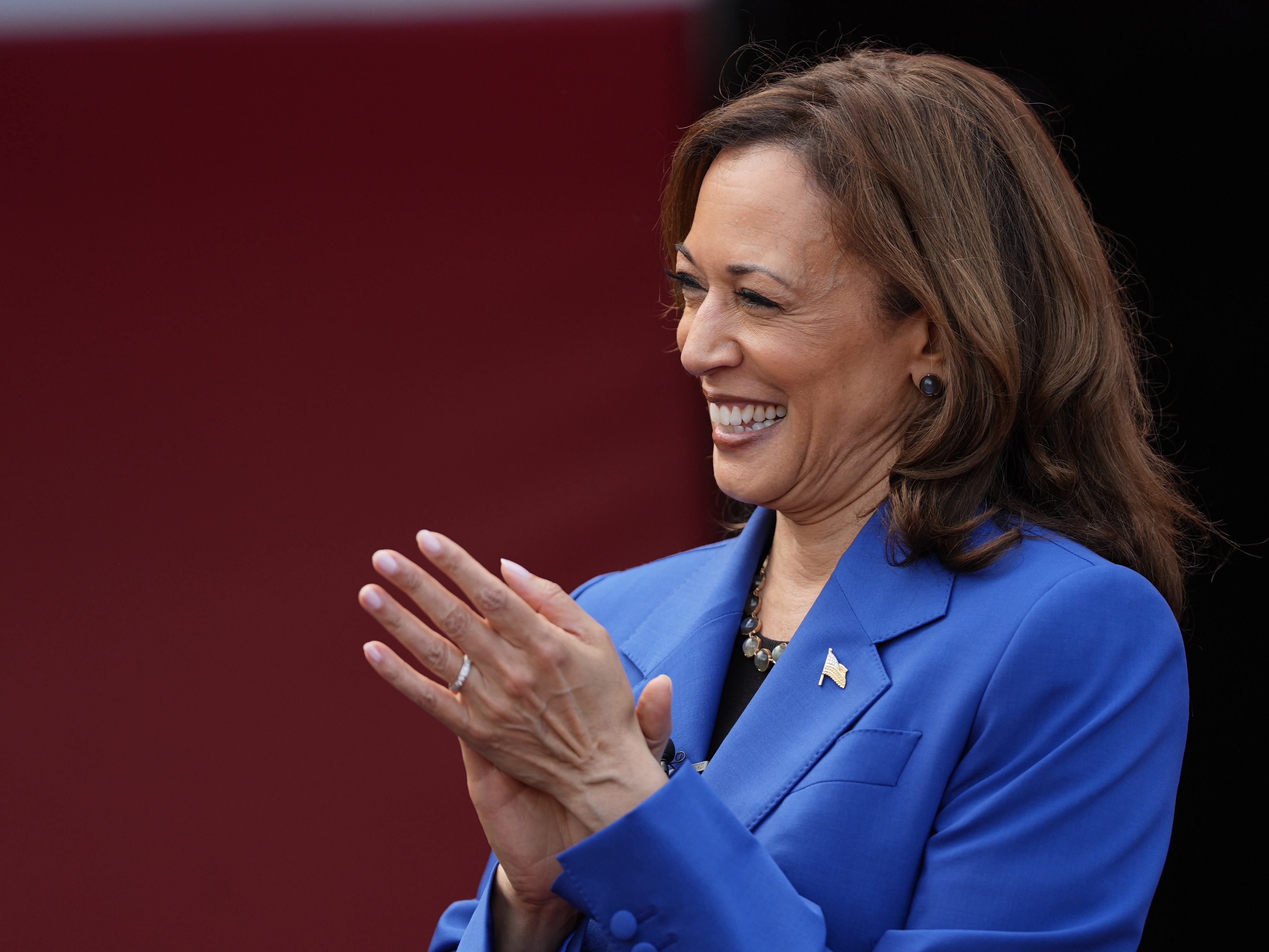 caption: Democratic presidential nominee Vice President Kamala Harris greets members of the Aliquippa High School football team during a campaign stop at their school, Sunday, Aug. 18, 2024, in Aliquippa, Pa.