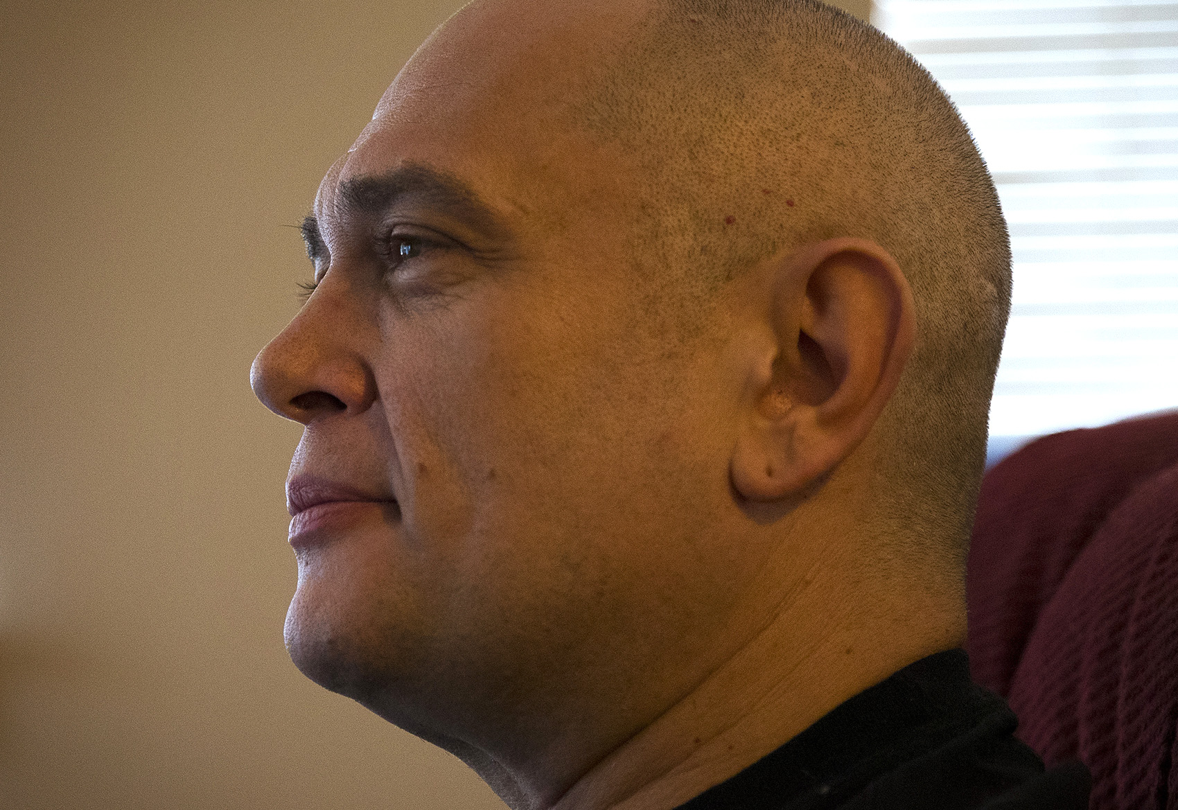 caption: Kevin Boggs sits during an interview on Friday, December 7, 2018, at his apartment in Seattle.