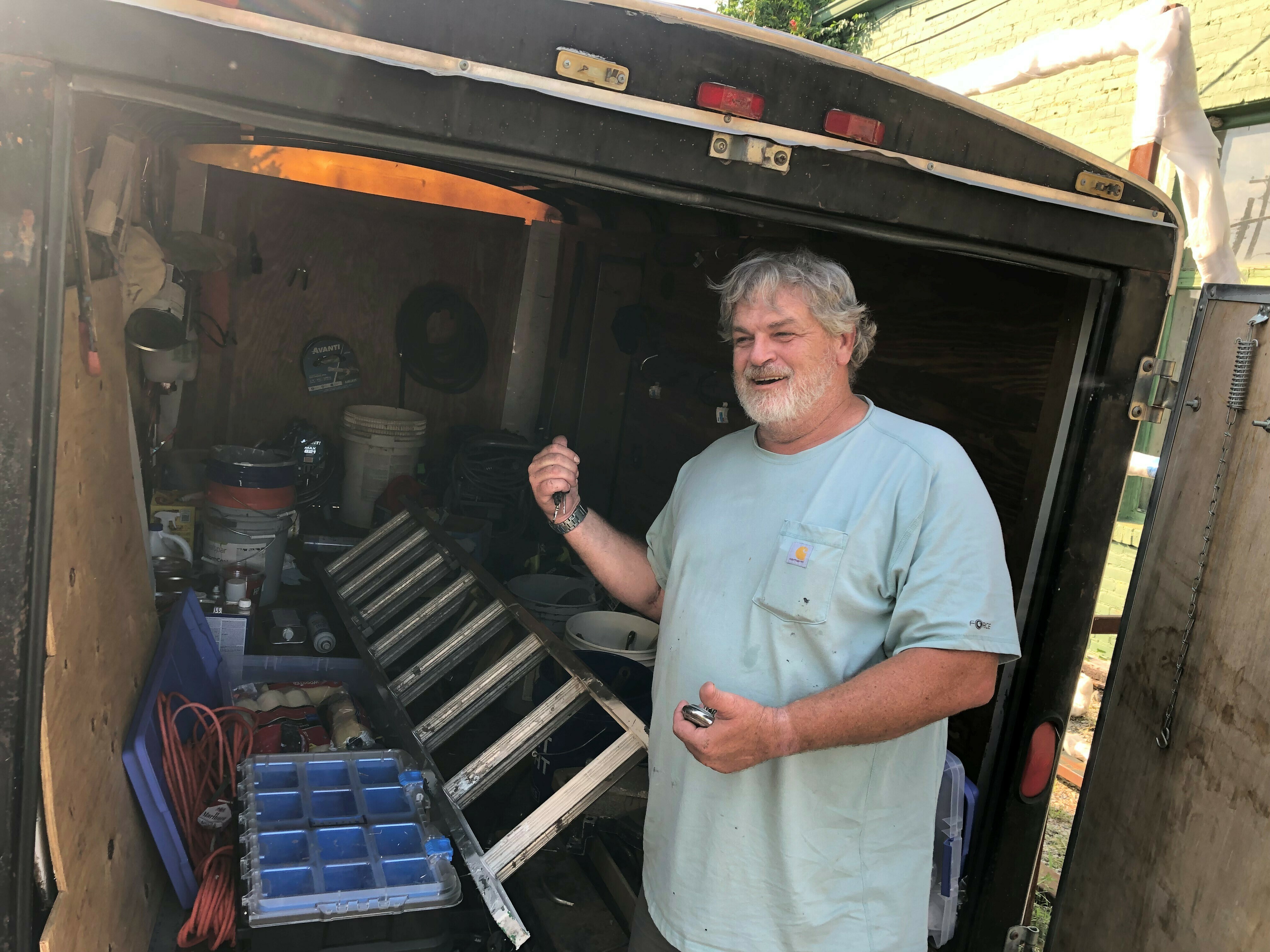 caption: Doug Layton, Jr. shows a trailer full of equipment he's acquired since being released from prison. He says he does painting and home repairs on the side, "trying to be productive in society."