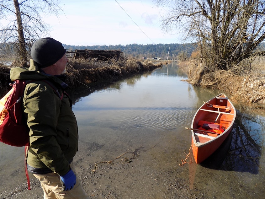 caption: Jim Haack gets ready to go to work. What appears to be a canal is actually Northeast 138th Street south of Duvall, Washington.