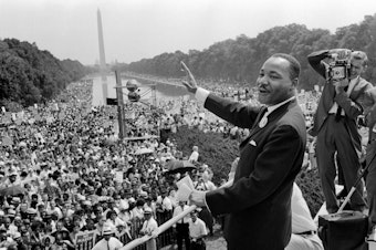 caption: Martin Luther King Jr. waves to the crowd during the "March on Washington" in 1963.