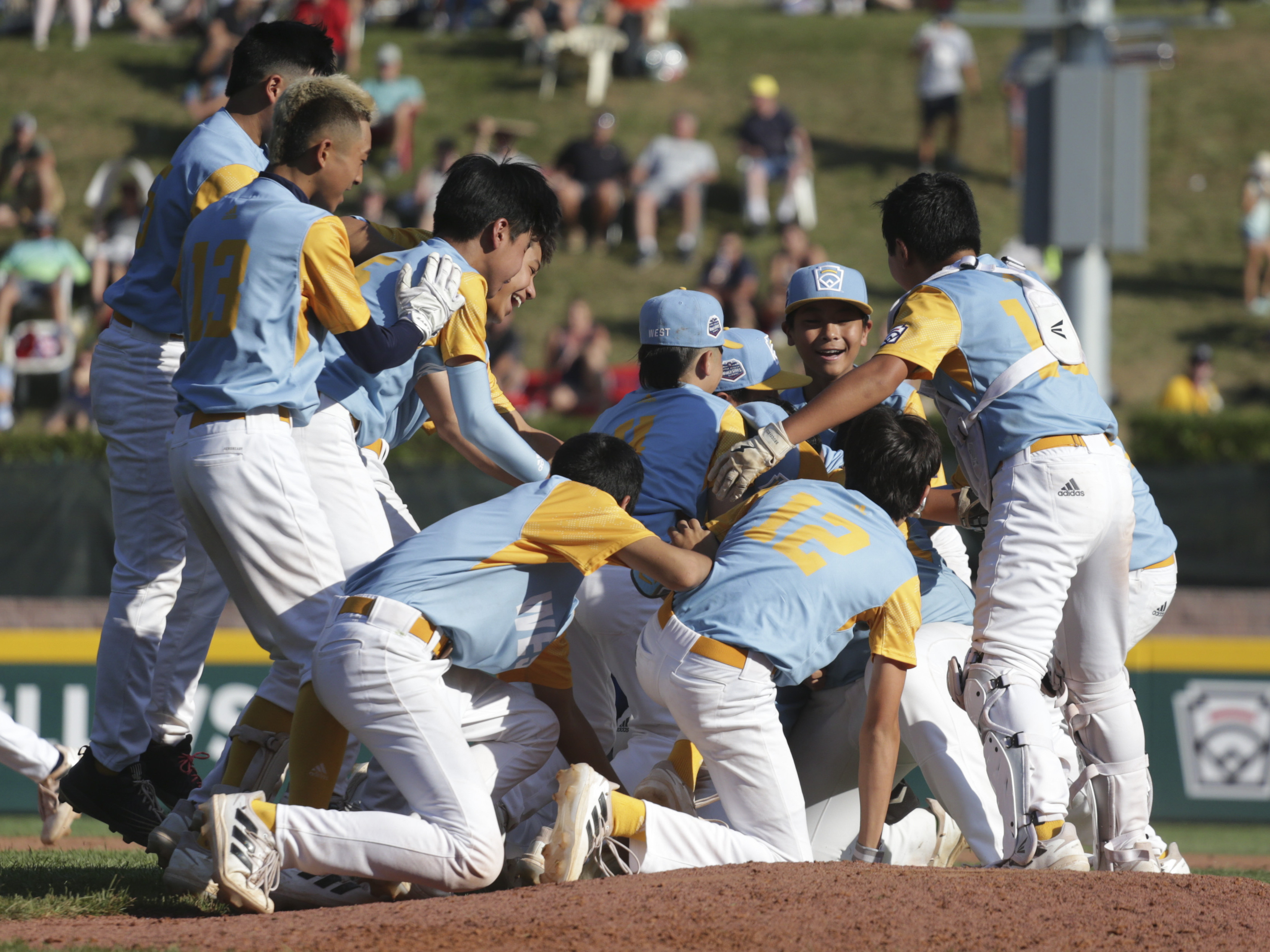 caption: Players from the West Region team from Honolulu celebrate winning the Little League World Series championship game in August.