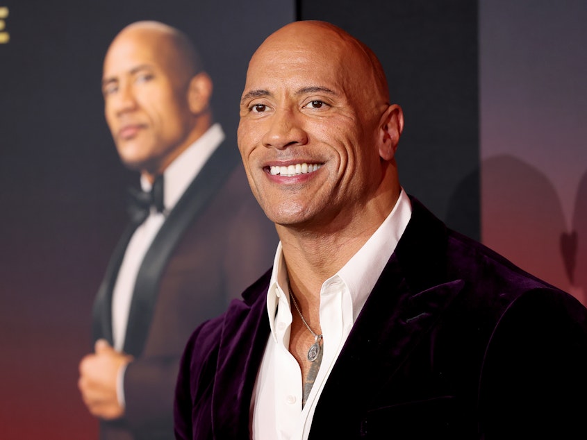caption: Dwayne Johnson attends the world premiere of Netflix's <em>Red Notice</em> on Wednesday in Los Angeles. Johnson says his production company will no longer use real guns on set.