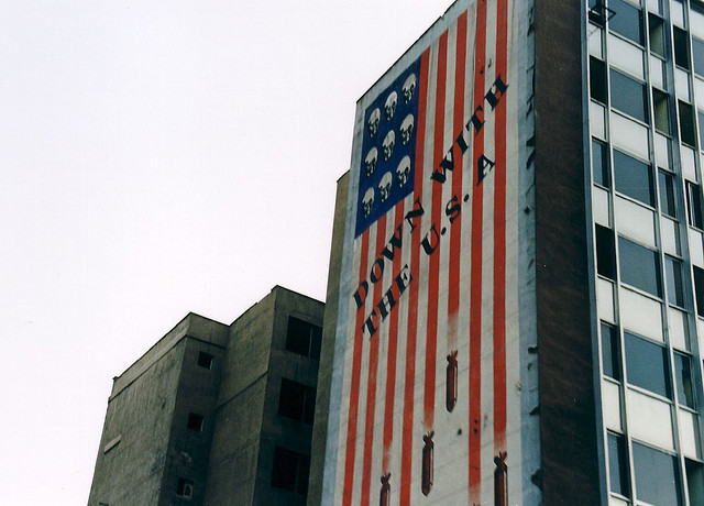 caption: A long-standing piece of political propoganda on a building in Tehran, Iran.