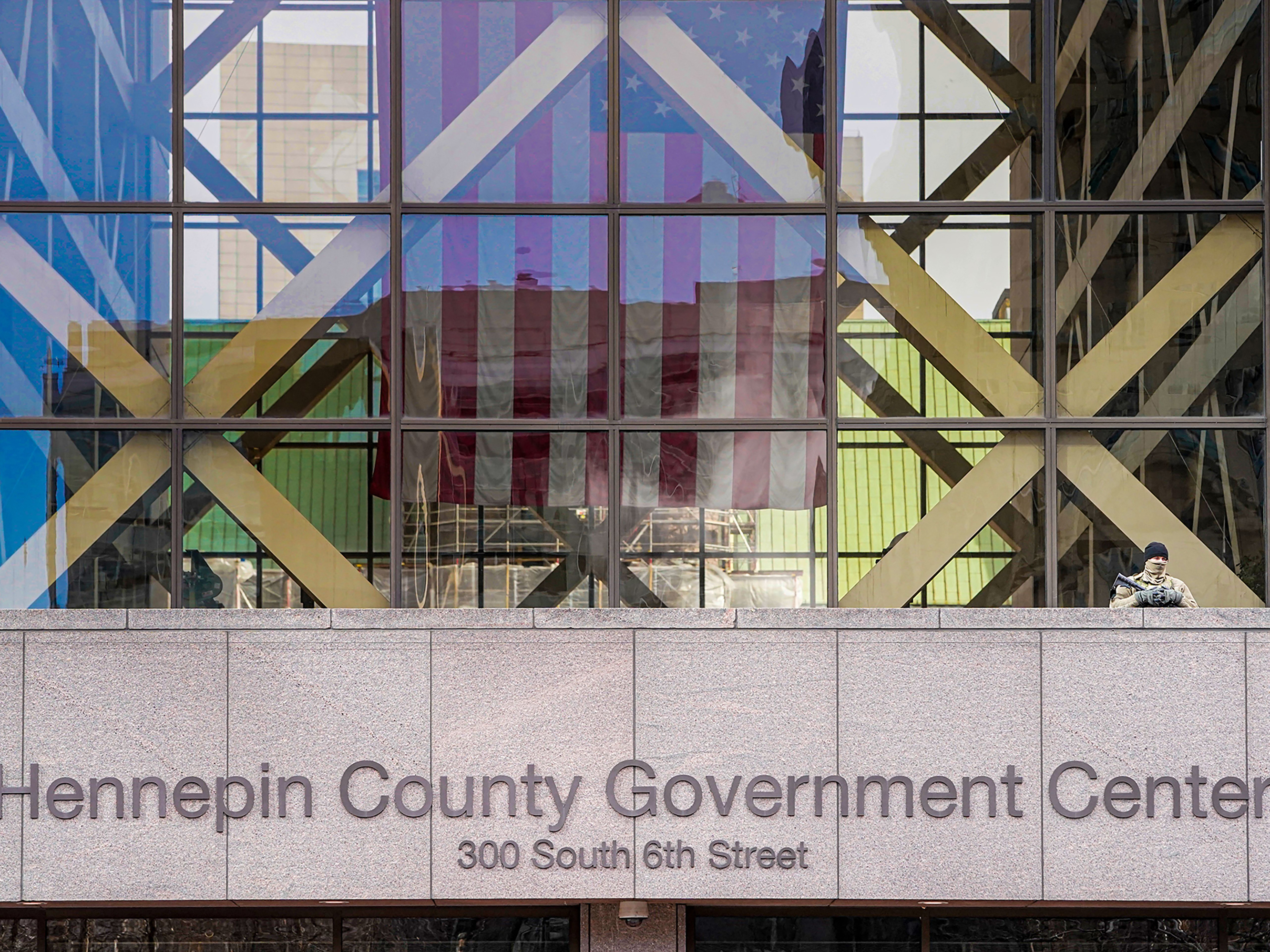caption: A member of the Minnesota National Guard stands outside the Hennepin County Government Center during jury selection in the trial of former Minneapolis Police officer Derek Chauvin on March 11, 2021 in Minneapolis. Chauvin is facing murder charges in George Floyd's death. Among the twelve jurors and three alternates selected are three Black men, one Black woman, and two multiracial jurors.