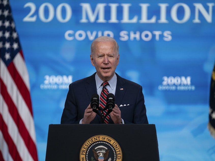 caption: When President Biden arrives to give his speech to a joint session of Congress on Wednesday night, he will be masked as he enters what will be a noticeably less crowded, more socially distanced House chamber. Here, Biden speaks about COVID-19 vaccinations at the White House.