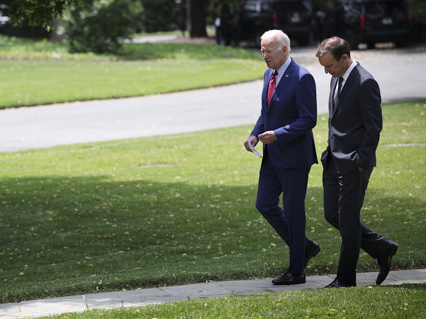 caption: U.S. President Joe Biden, left, talks with Sen. Chris Murphy, D-Conn., outside the Oval Office of the White House on Tuesday as the two discuss ongoing negotiations in the Senate around gun law legislation.