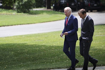 caption: U.S. President Joe Biden, left, talks with Sen. Chris Murphy, D-Conn., outside the Oval Office of the White House on Tuesday as the two discuss ongoing negotiations in the Senate around gun law legislation.