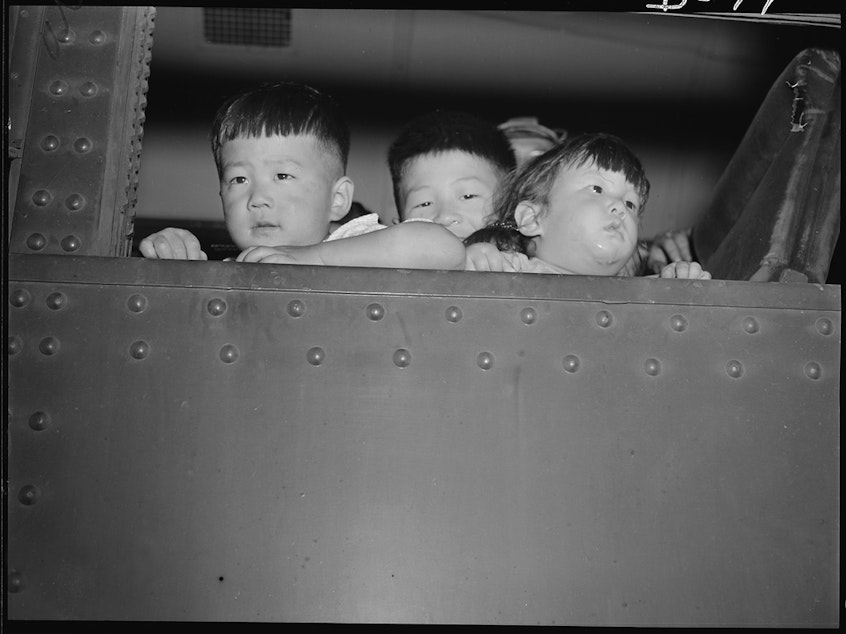 caption: Eden, Idaho. Gerald, 5, David, 6 and Chester Sakura, Jr., 1 1/2 brothers. These little evacuees, along with 600 others from the Puyallup assembly center, have just arrived here and will spend the duration at the Minidoka War Relocation Authority center.