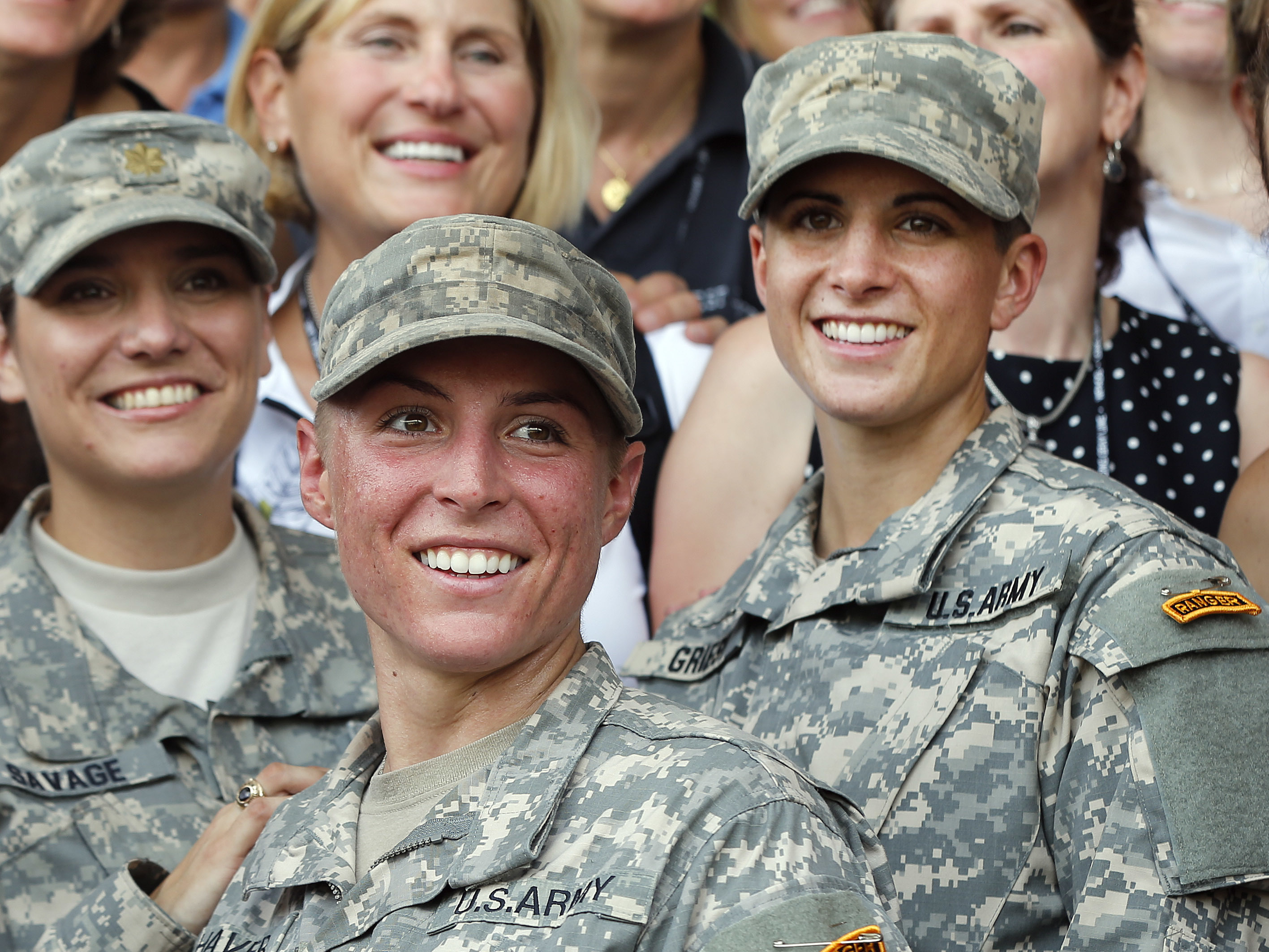 caption: Army 1st Lt. Shaye Haver, center, and Capt. Kristen Griest, right, pose for photos with other female West Point alumni after an Army Ranger school graduation ceremony at Fort Benning, Ga, in 2015. They were the first two women to graduate from U.S. Army Ranger school.