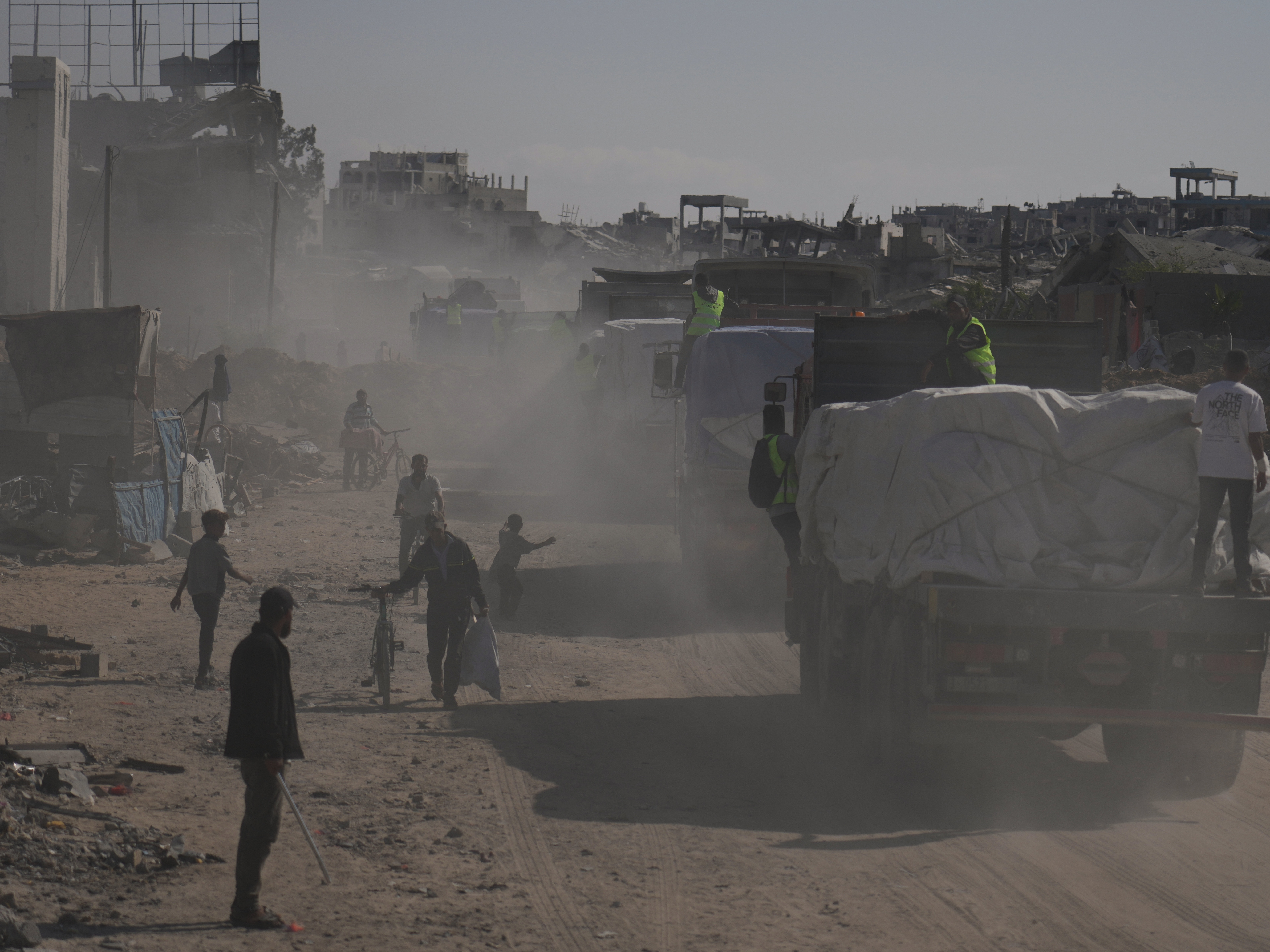 caption: Trucks carrying aid from the United Nations' World Food Programme drive through Khan Younis, southern Gaza Strip, Sunday.