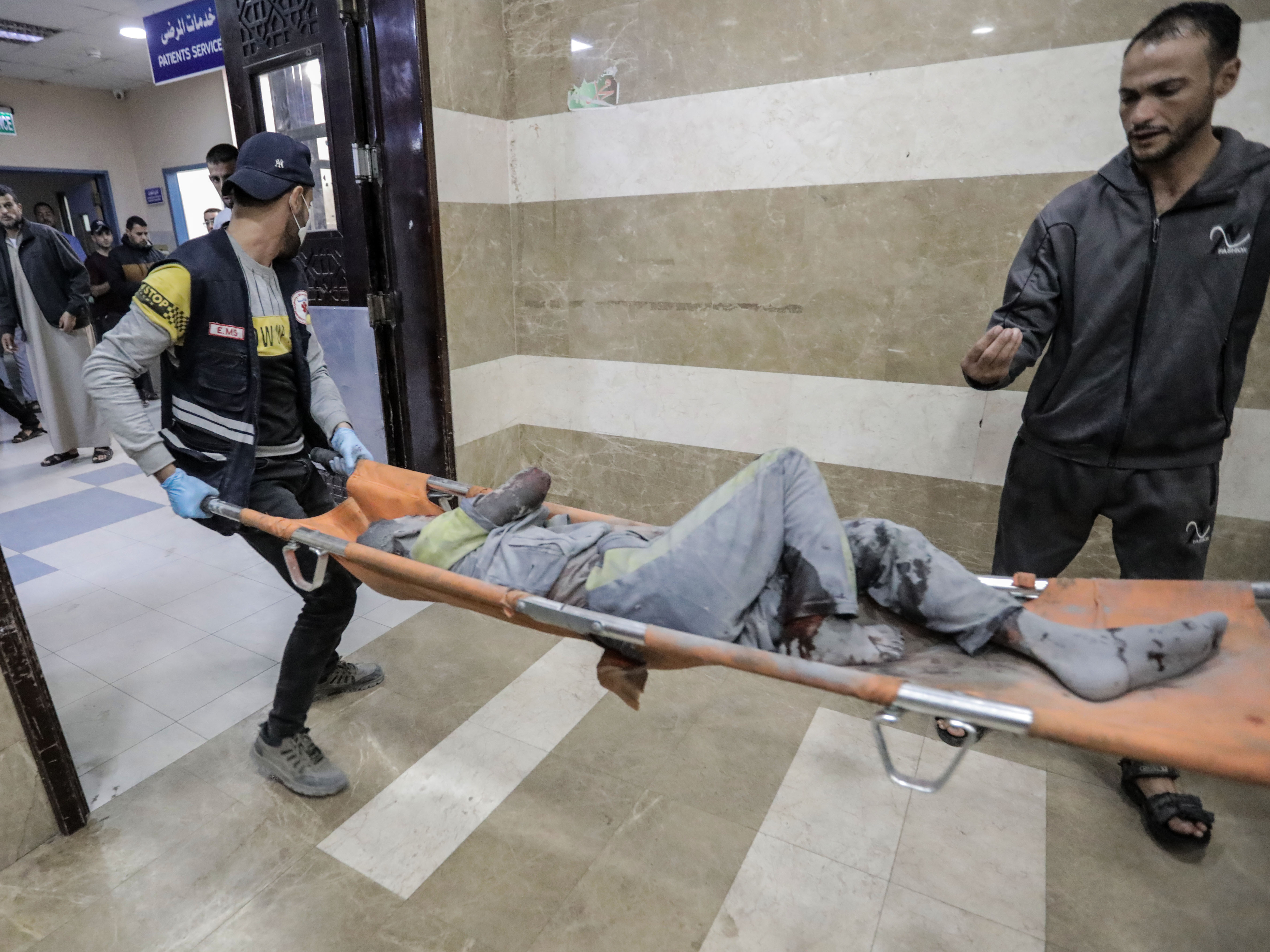 caption: Palestinians injured in Israeli raids arrive at Nasser Medical Hospital on Tuesday in Khan Younis, Gaza.