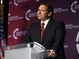 caption: Florida Gov. Ron DeSantis' flight that took 50 migrants to Martha's Vineyard, Mass., is being investigated by the Bexar County Sheriff's Office in Texas. The migrants were flown from Texas to Florida and then on to Martha's Vineyard. Here, DeSantis speaks at a rally on Aug. 19 in Pittsburgh.