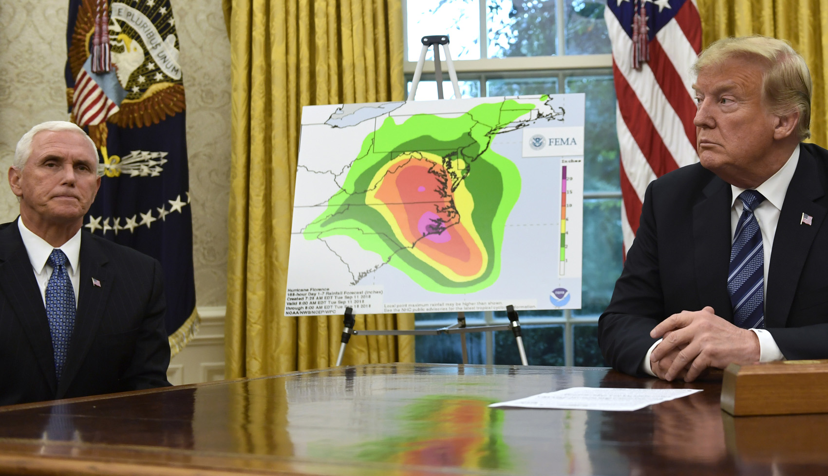 caption: President Donald Trump, right, and Vice President Mike Pence, left, listen during a briefing on Hurricane Florence in the Oval Office of the White House in Washington, Tuesday, Sept. 11, 2018. (AP Photo/Susan Walsh)