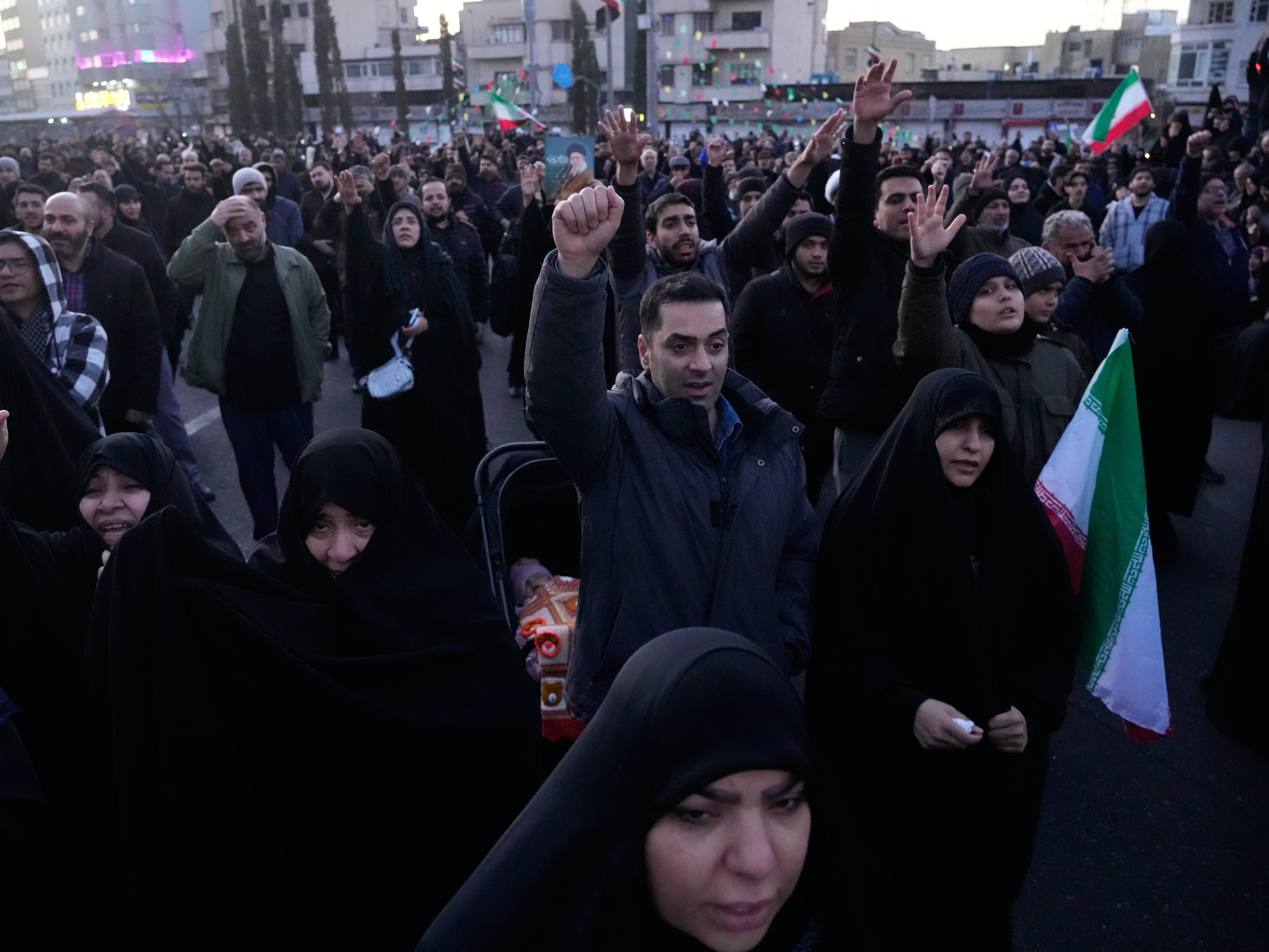 caption: Government supporters chant slogans as they gather in mourning after state TV officially announced the death of Iranian Supreme Leader Ayatollah Ali Khamenei, in Tehran, Iran, Sunday, March 1, 2026.
