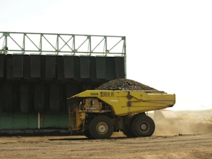 caption: A giant truck hauls coal at a mine in the Powder River Basin in Wyoming