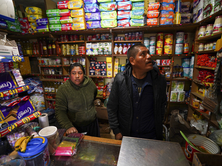 caption: Jose Gonzalez and his wife Maria, wait for customers in their corner shop that he remodeled, stocked and extended with money he earned over a decade working in the United States, in the Purepecha Indigenous community of Comachuen, Michoacan state, Mexico, Wednesday, Jan. 19, 2022. (AP Photo/Fernando Llano)