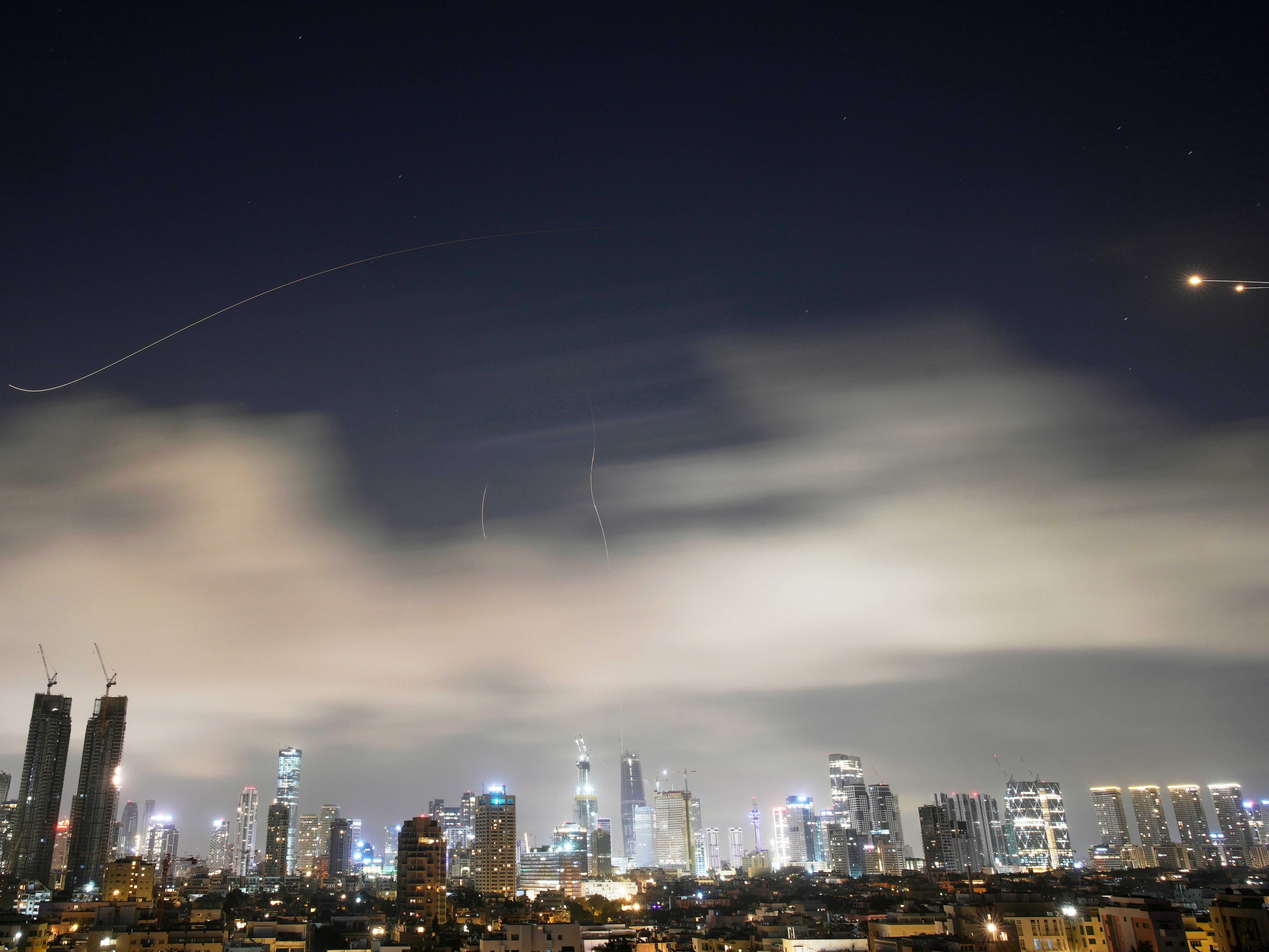 caption: Israeli air defense system fires to intercept missiles during an Iranian attack over Tel Aviv, Israel, early Sunday, March 15, 2026.
