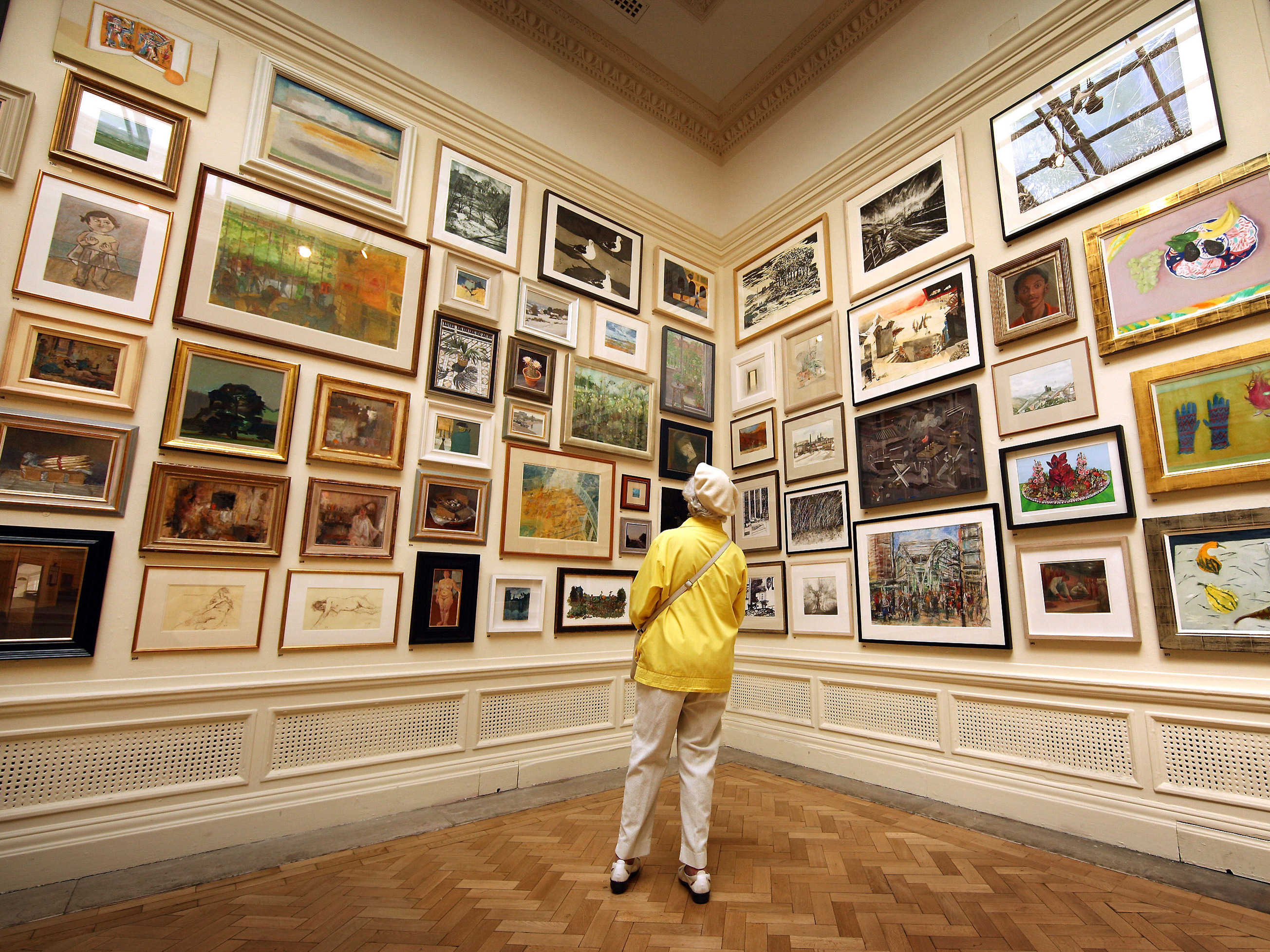 caption: In her new book <em>Get the Picture, </em>journalist Bianca Bosker explores why connecting with art sometimes feels harder than it has to be. Above, a visitor takes in paintings at The Royal Academy Summer Exhibition in London in 2010.