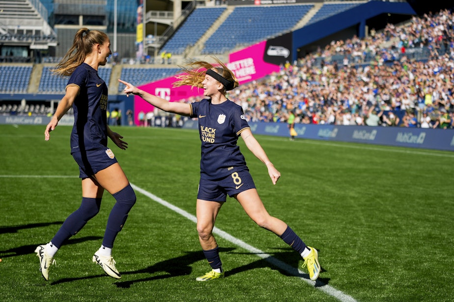 caption: Seattle Reign forward Bethany Balcer, right, points at teammate Jordyn Huitema after scoring on a penalty kick won by Huitema against the Washington Spirit during the first half of an NWSL soccer match Sunday, March 17, 2024, in Seattle.