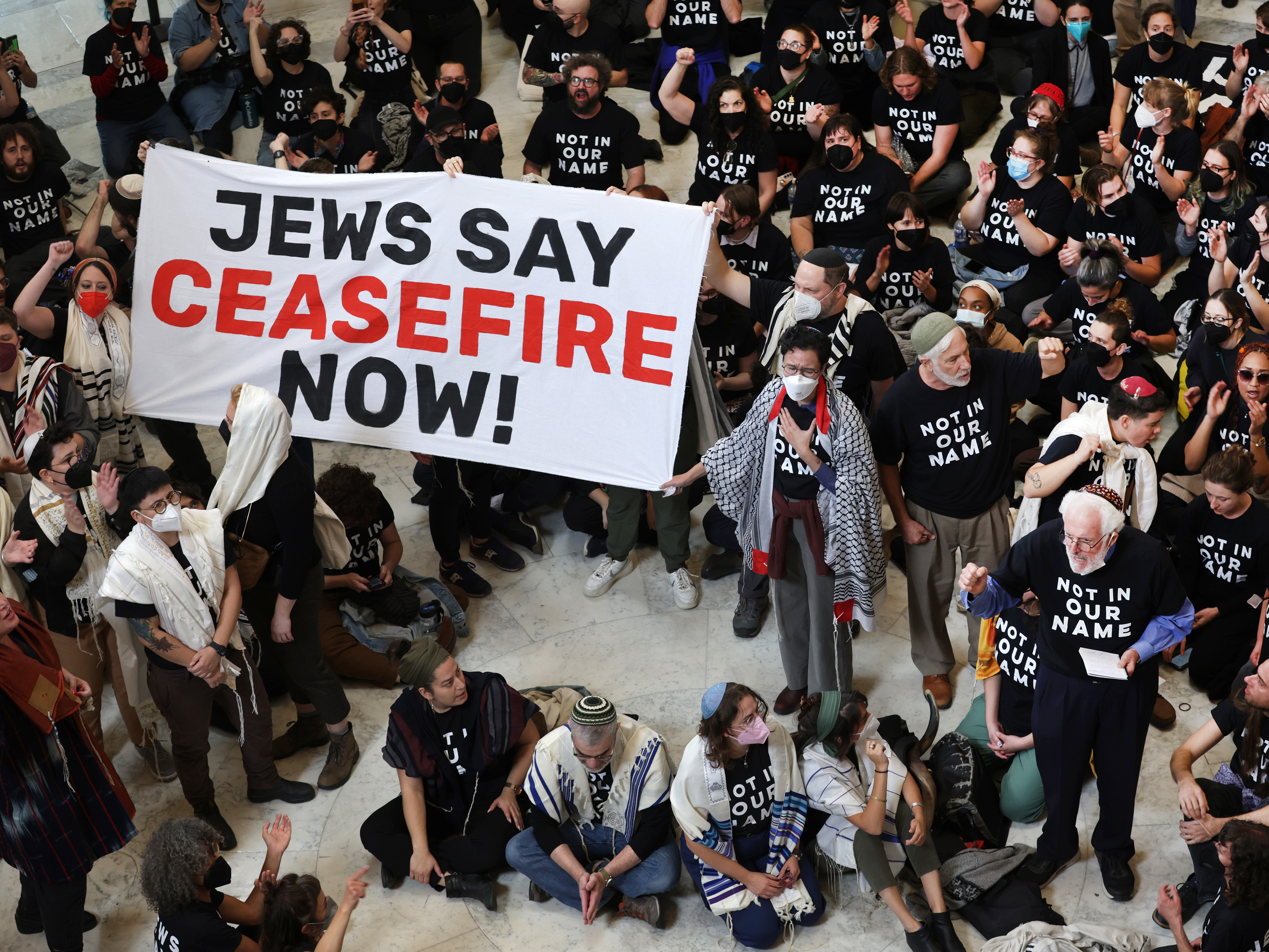 caption: Members of the Jewish Voice for Peace and the If Not Now movement, two Jewish activist groups, stage a rally to call for a cease fire in the Israel–Hamas war.