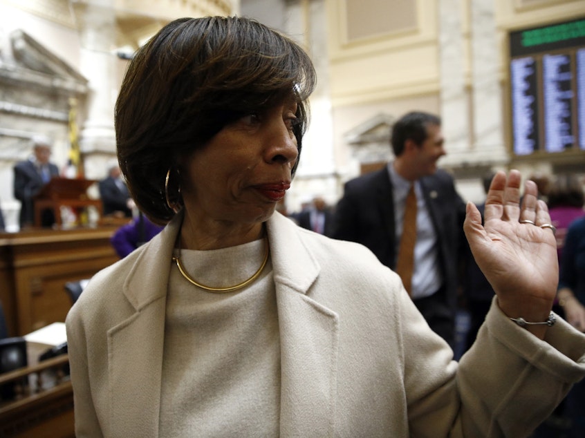 caption: Former Baltimore Mayor Catherine Pugh walks on the Maryland House of Delegates chamber floor in January. On Wednesday, Pugh was federally indicted over what the government says was a fraudulent scheme involving the sale of children's books.