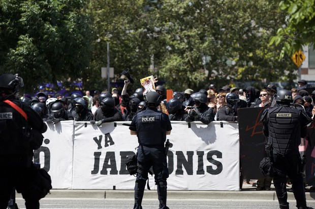 caption: <p>Portland Police in riot gear stand between right-wing protesters and counter-protesters.</p>